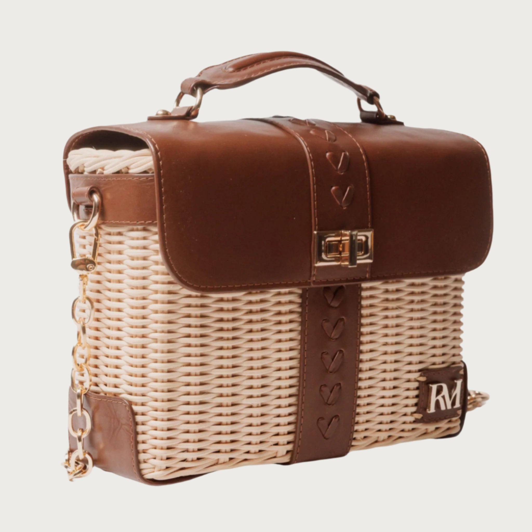 Structured handbag with woven rattan body, leather flap and trim, gold hardware, and top handle — elegant and artisan-crafted