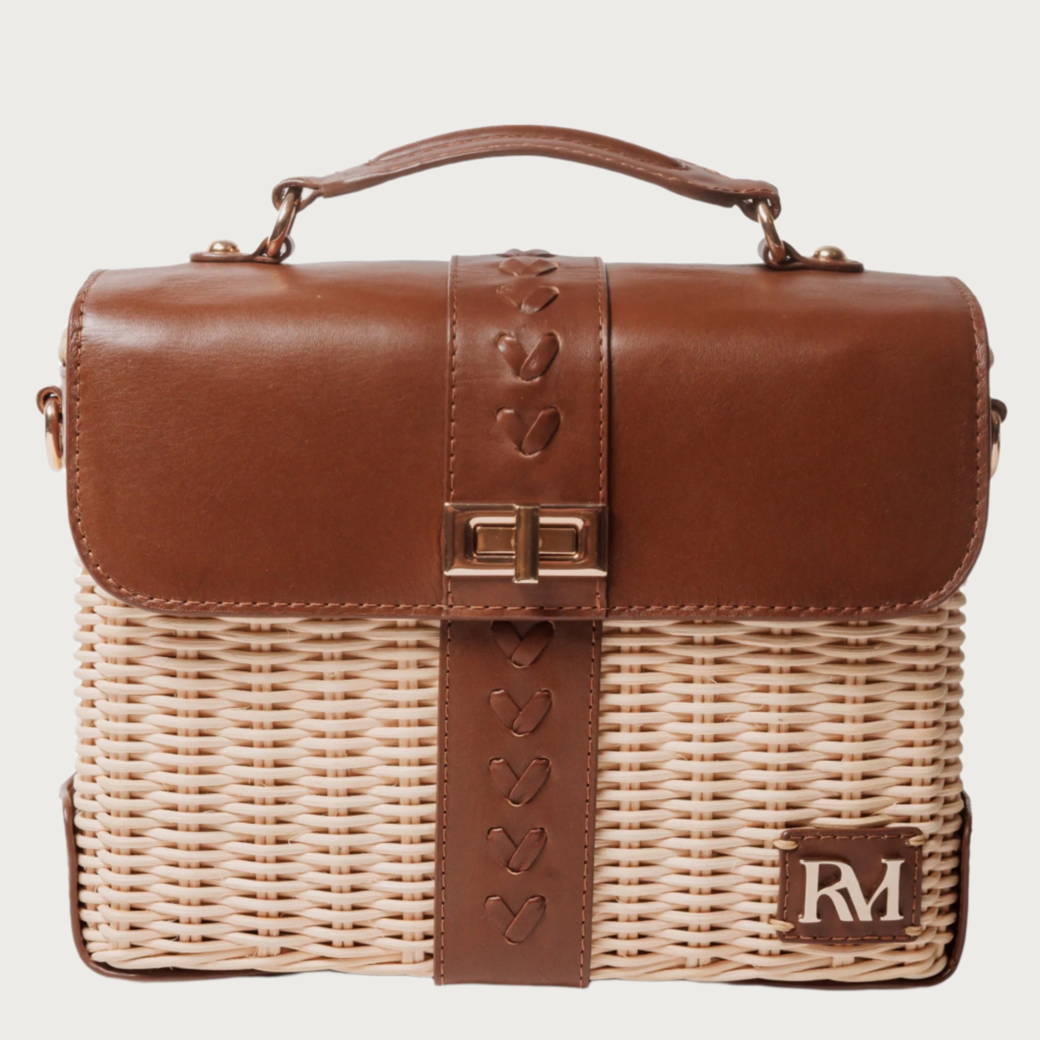 Structured handbag with woven rattan body, leather flap and trim, gold hardware, and top handle — elegant and artisan-crafted
