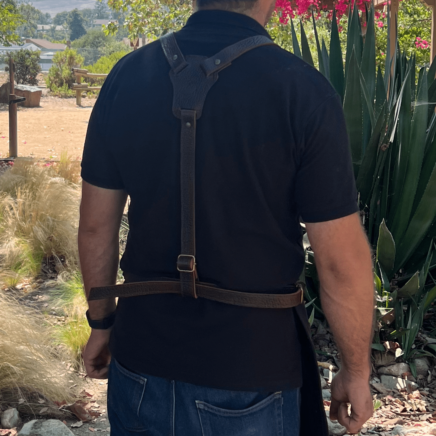 Canvas and leather apron with adjustable straps, chest pocket, and tool loops — durable stylish for grilling, crafts, or work