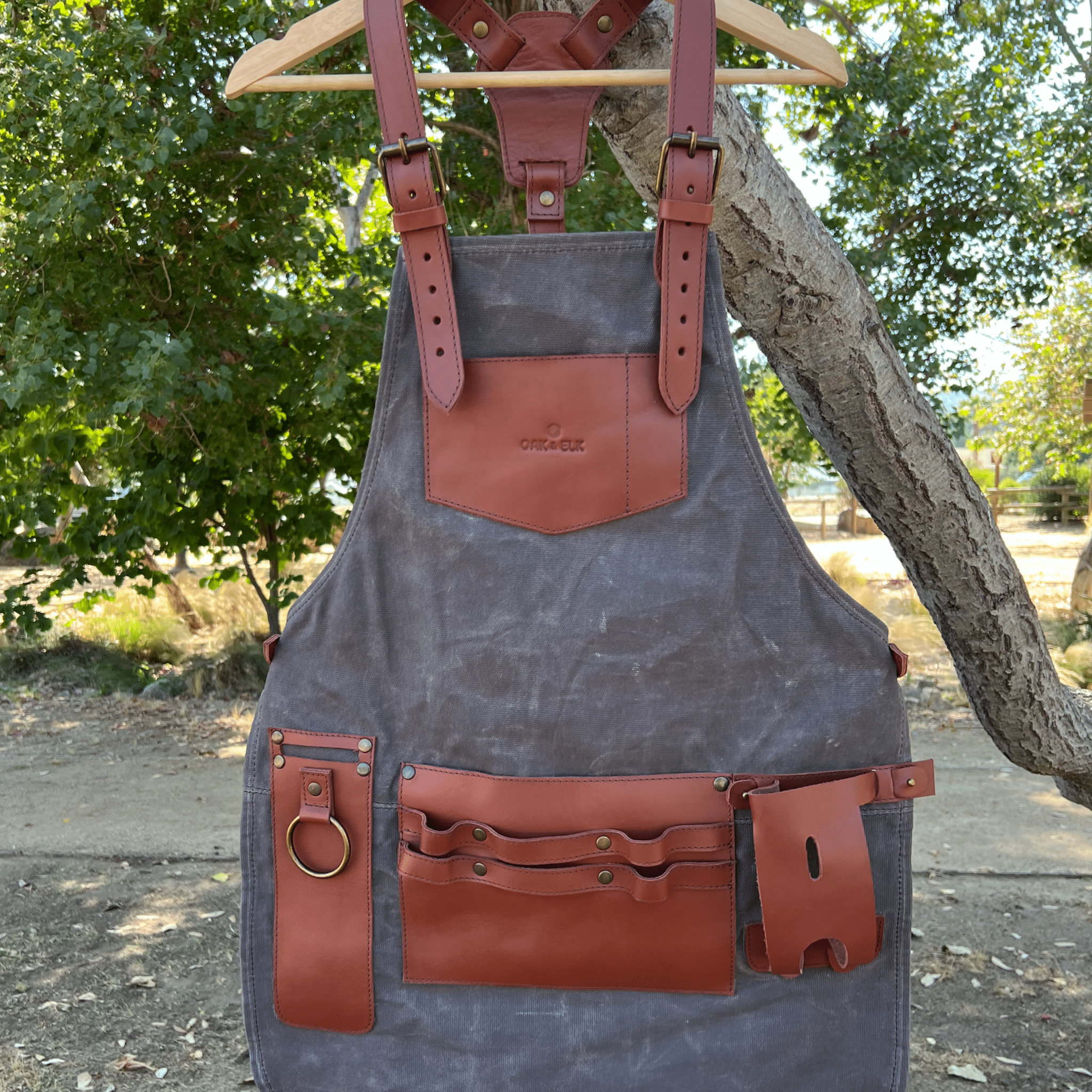 Canvas and leather apron with adjustable straps, chest pocket, and tool loops — durable stylish for grilling, crafts, or work