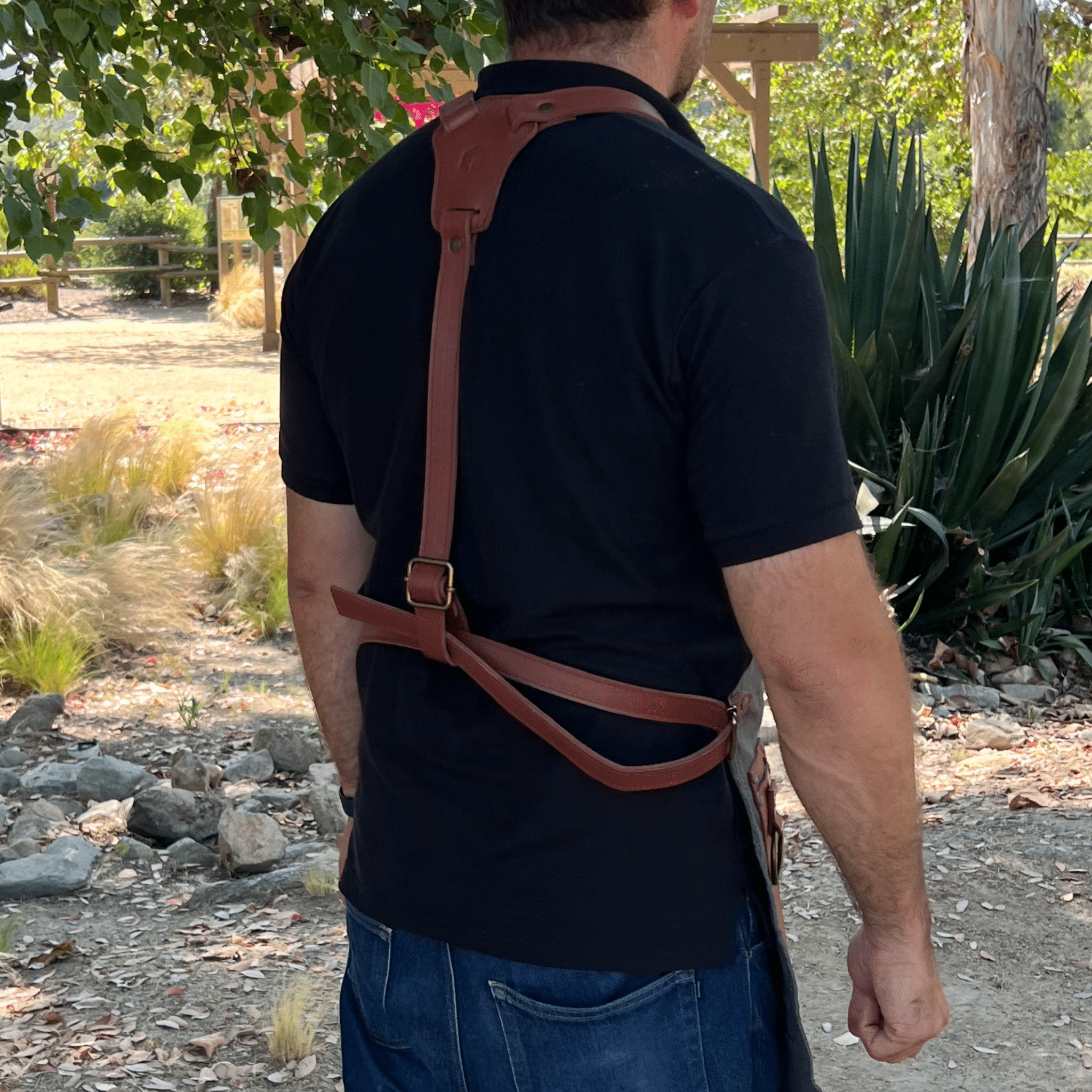 Canvas and leather apron with adjustable straps, chest pocket, and tool loops — durable stylish for grilling, crafts, or work