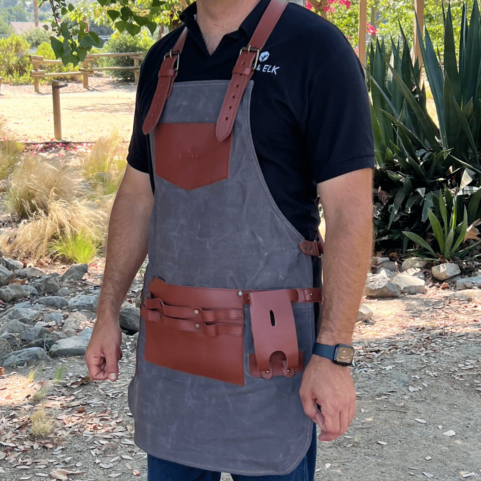 Canvas and leather apron with adjustable straps, chest pocket, and tool loops — durable stylish for grilling, crafts, or work