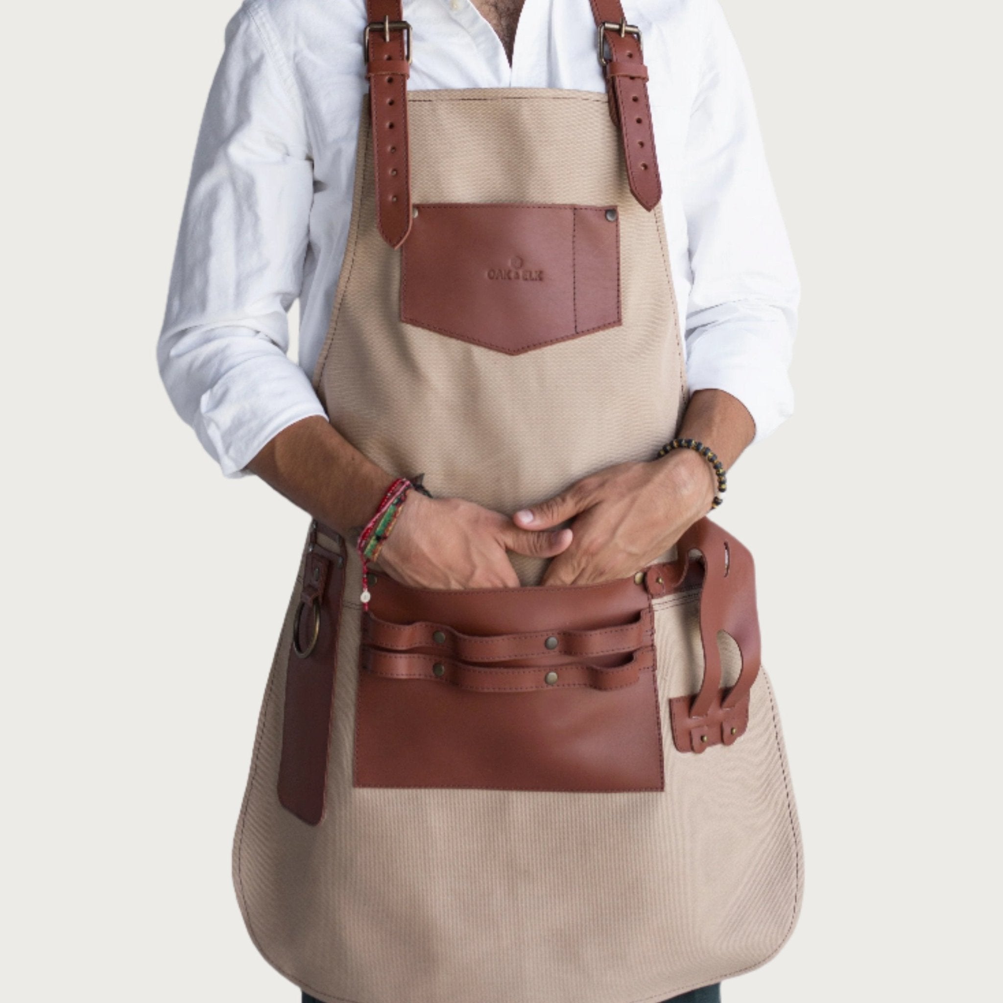 Canvas and leather apron with adjustable straps, chest pocket, and tool loops — durable stylish for grilling, crafts, or work