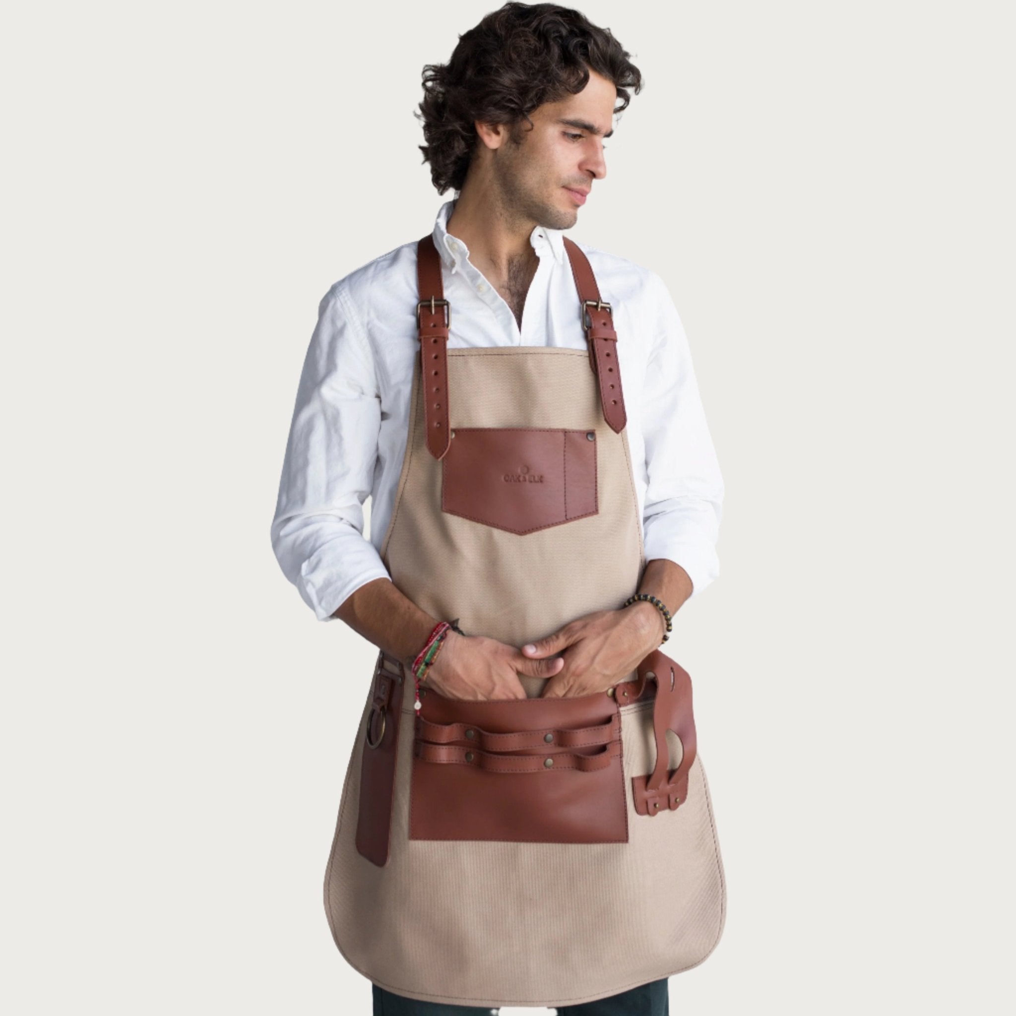 Canvas and leather apron with adjustable straps, chest pocket, and tool loops — durable stylish for grilling, crafts, or work