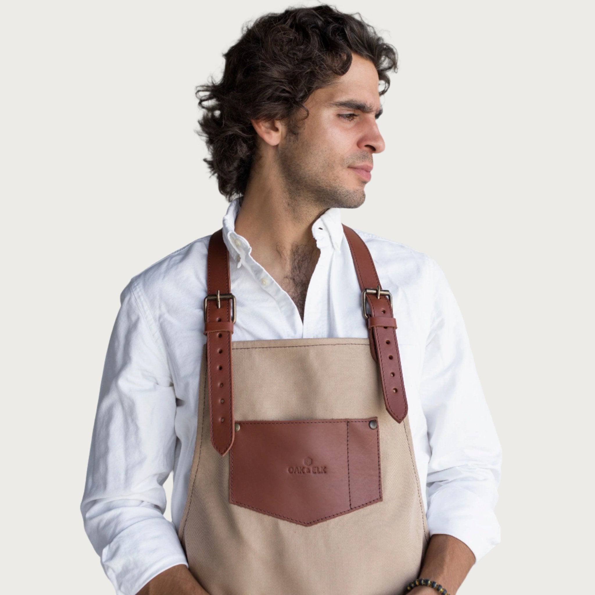 Canvas and leather apron with adjustable straps, chest pocket, and tool loops — durable stylish for grilling, crafts, or work