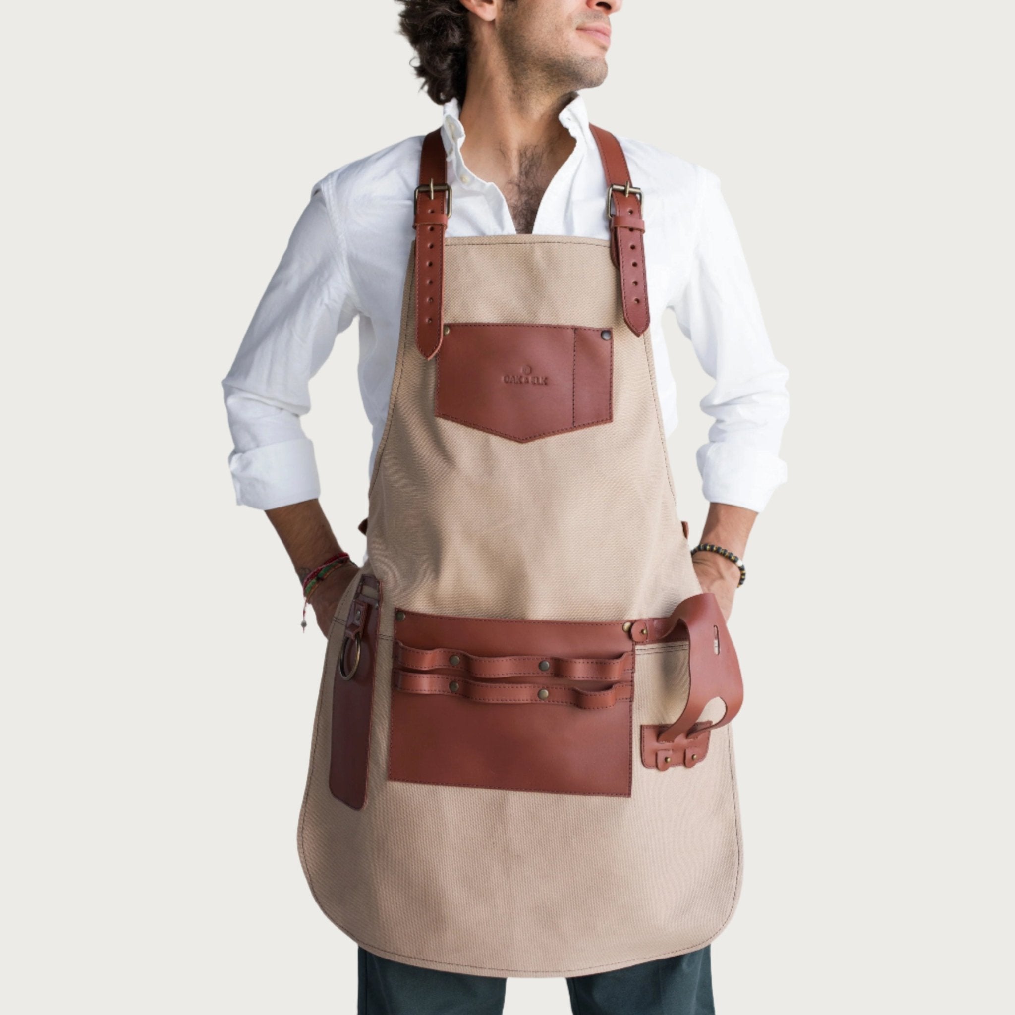 Canvas and leather apron with adjustable straps, chest pocket, and tool loops — durable stylish for grilling, crafts, or work