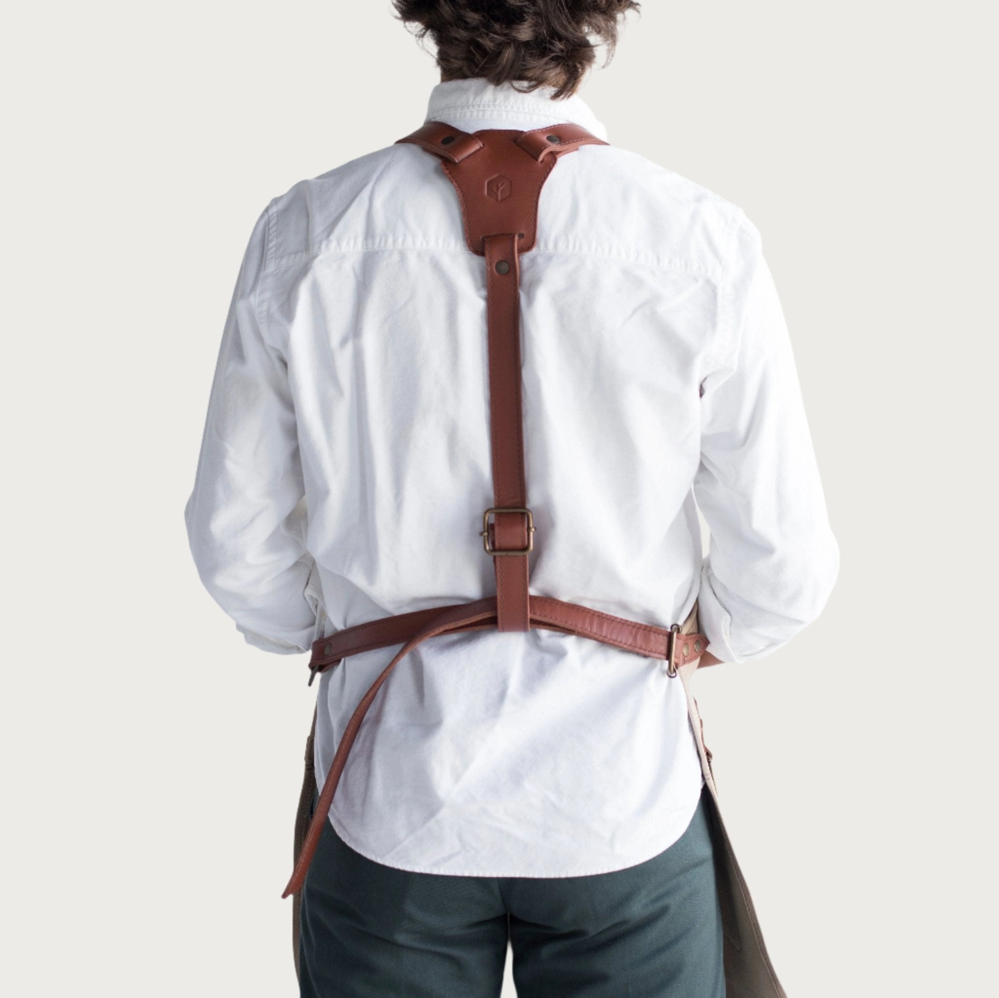 Canvas and leather apron with adjustable straps, chest pocket, and tool loops — durable stylish for grilling, crafts, or work