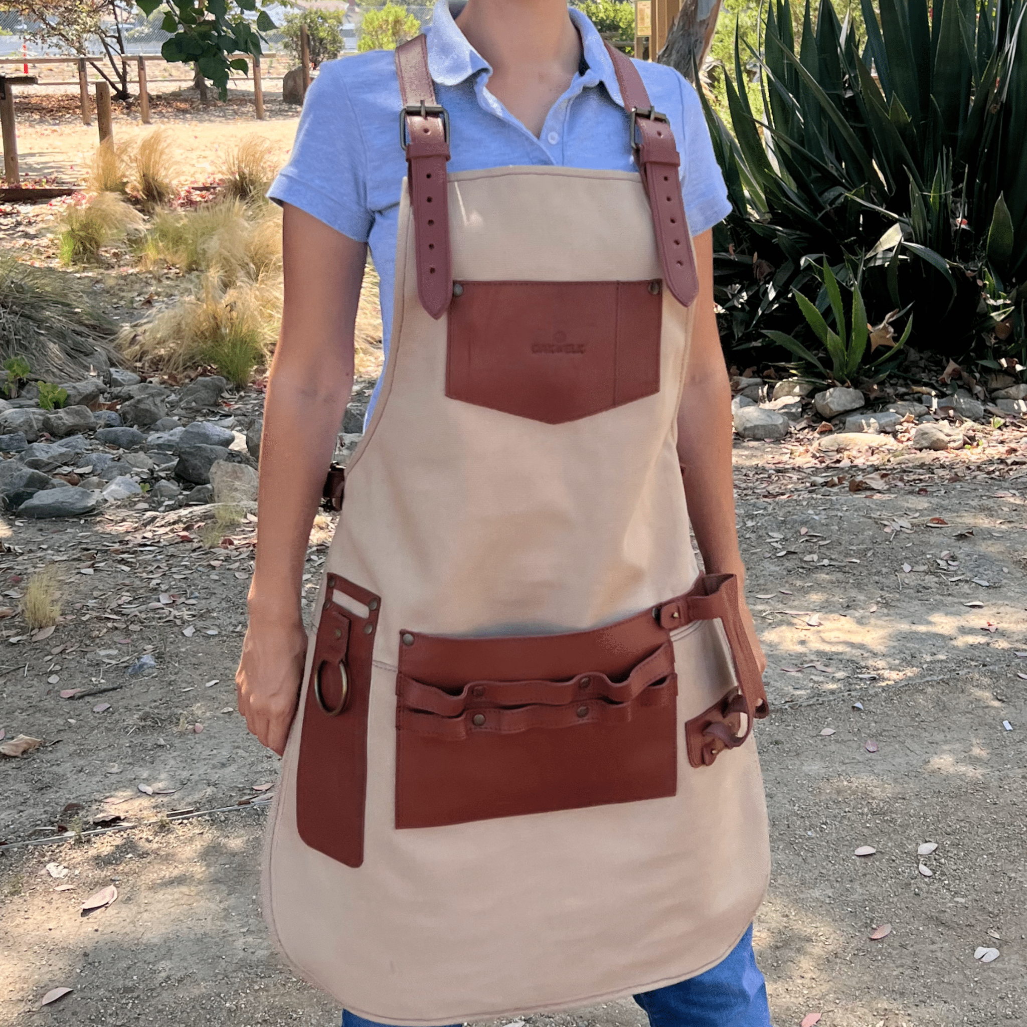 Canvas and leather apron with adjustable straps, chest pocket, and tool loops — durable stylish for grilling, crafts, or work