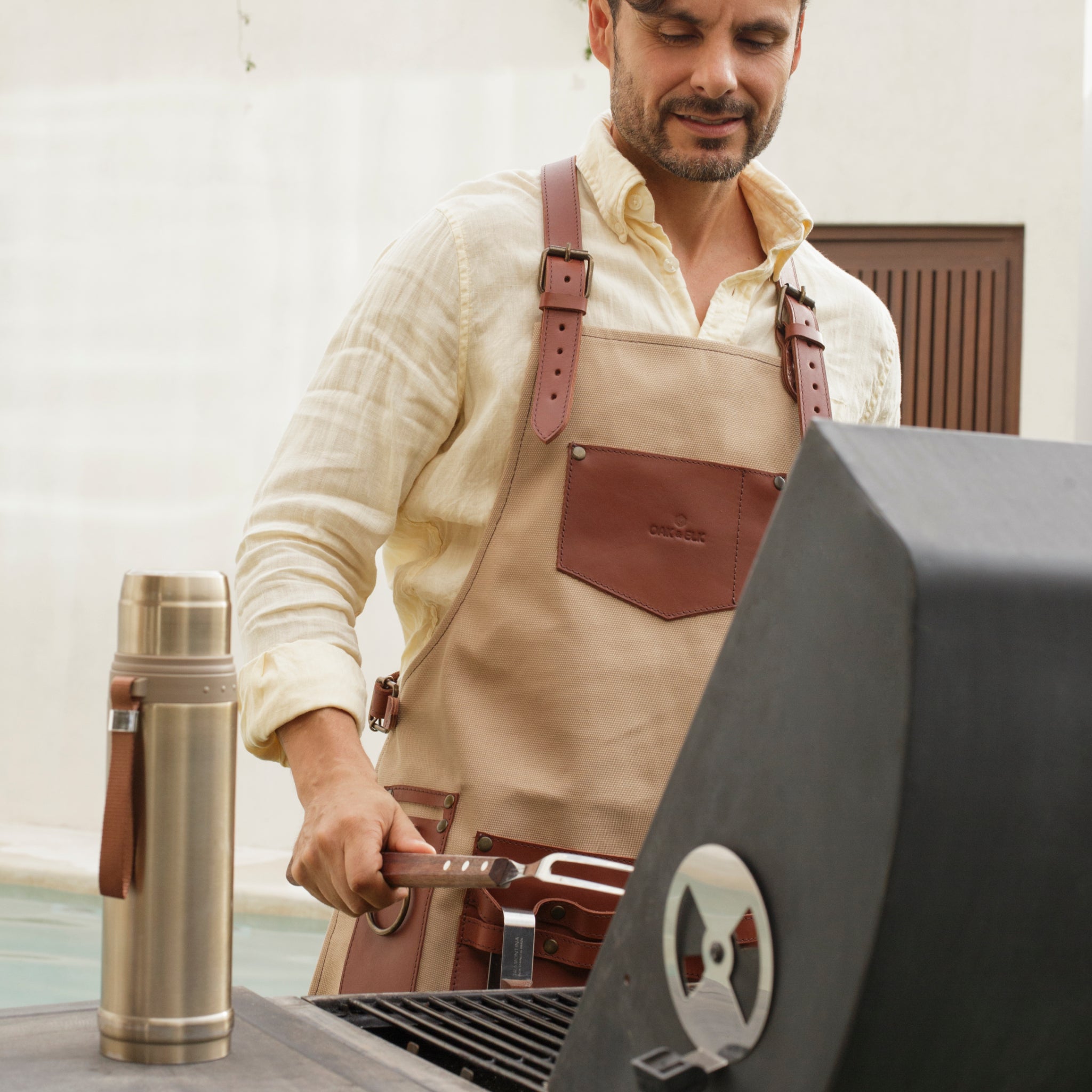 Canvas and leather apron with adjustable straps, chest pocket, and tool loops — durable stylish for grilling, crafts, or work