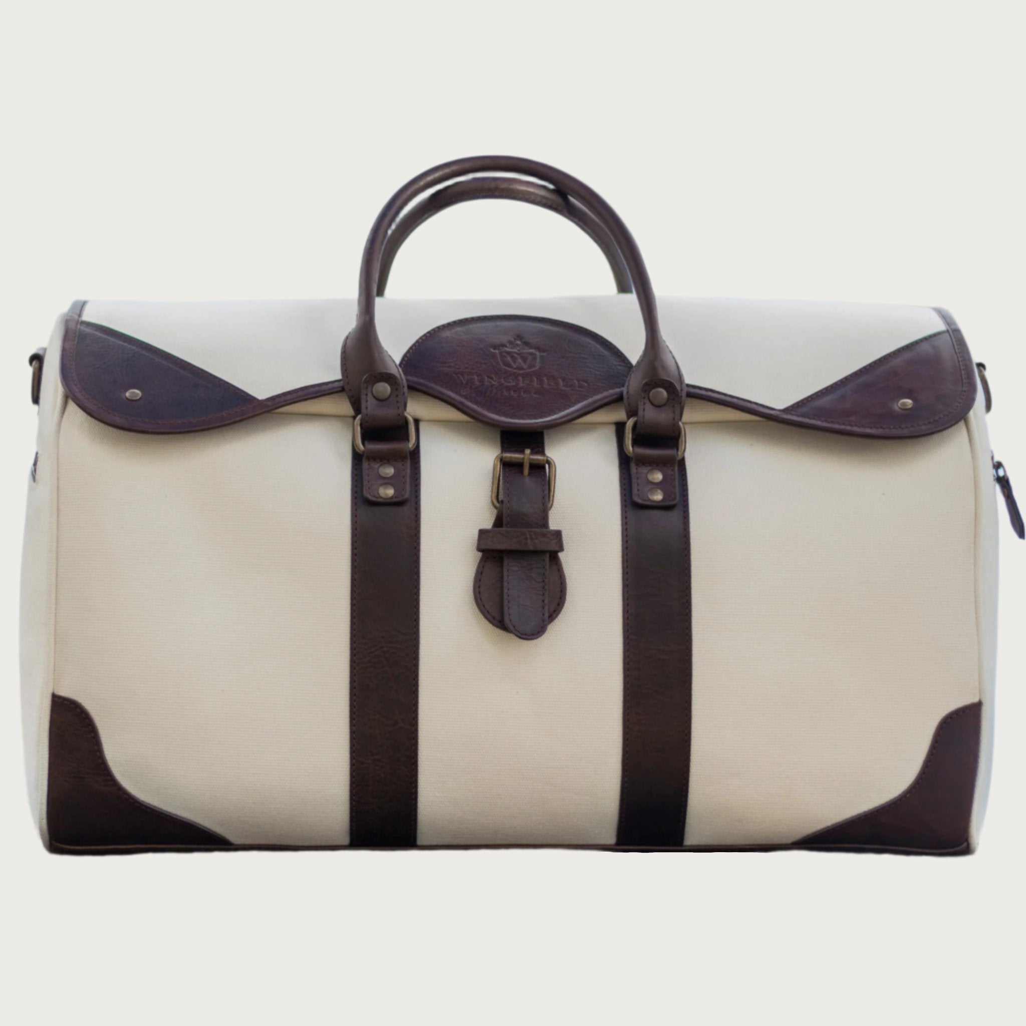 Large canvas and leather duffel bag with top handles, adjustable shoulder strap, leather trim, and zip closure, for travel