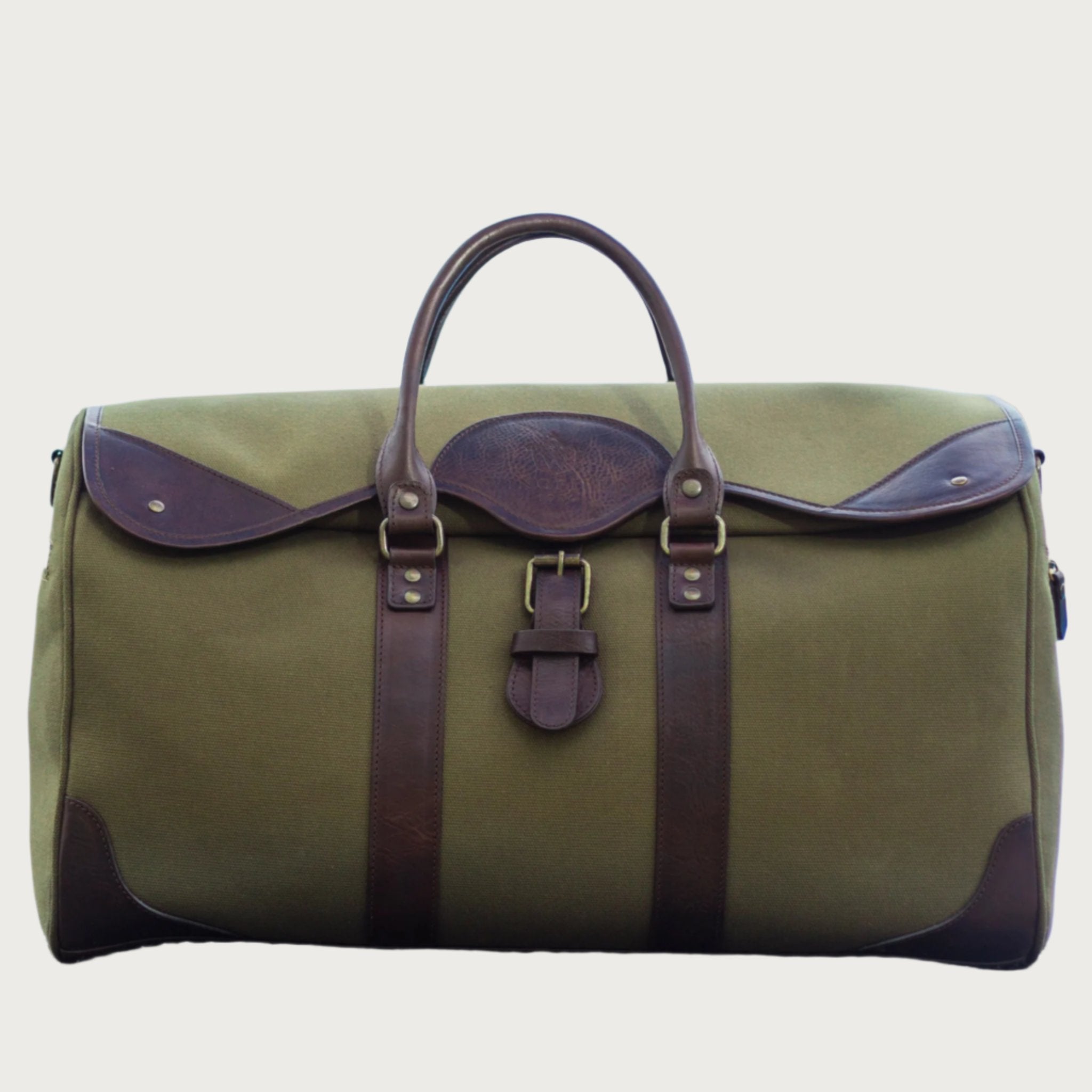 Large canvas and leather duffel bag with top handles, adjustable shoulder strap, leather trim, and zip closure, for travel