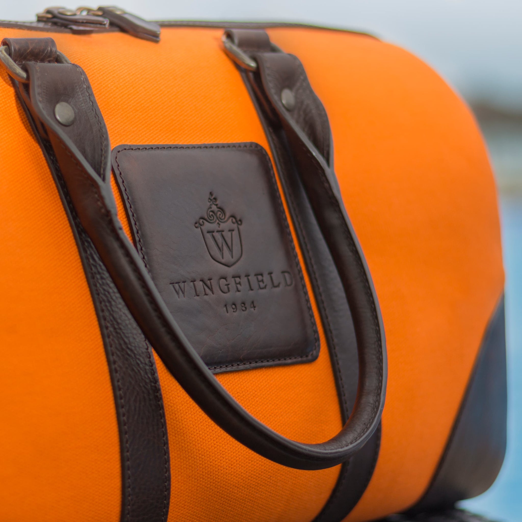 Compact canvas and leather duffel bag with top handles, adjustable shoulder strap, leather accents, zip closure travel ready