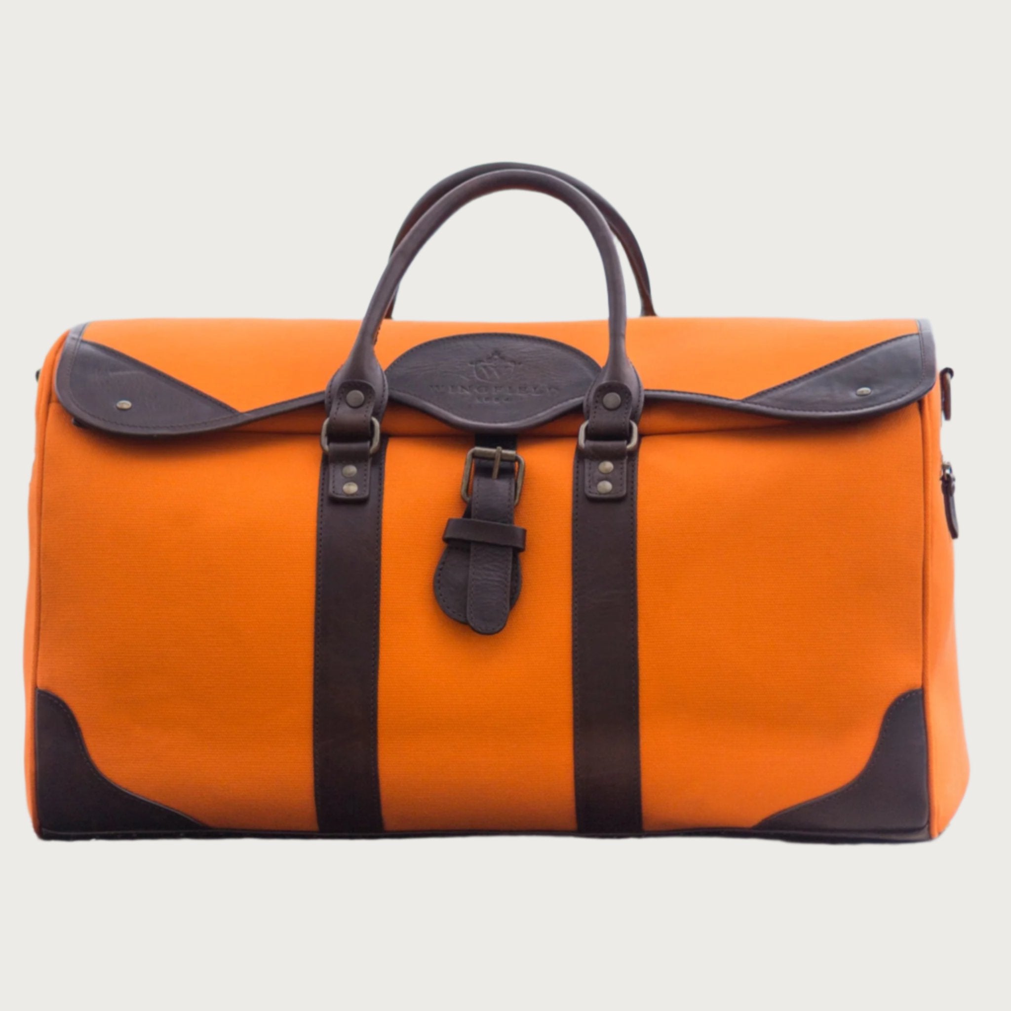 Large canvas and leather duffel bag with top handles, adjustable shoulder strap, leather trim, and zip closure, for travel