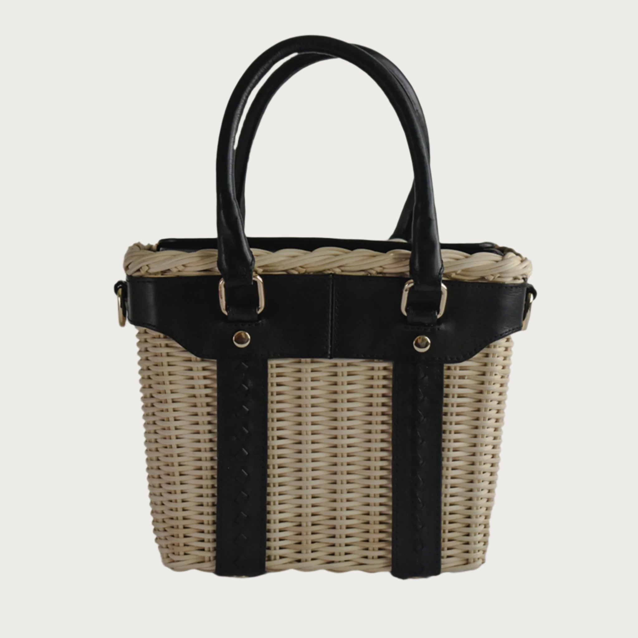 Leather and wicker tote bag with structured body, dual top handles, inner lining, and chain strap, elegant handcrafted feel