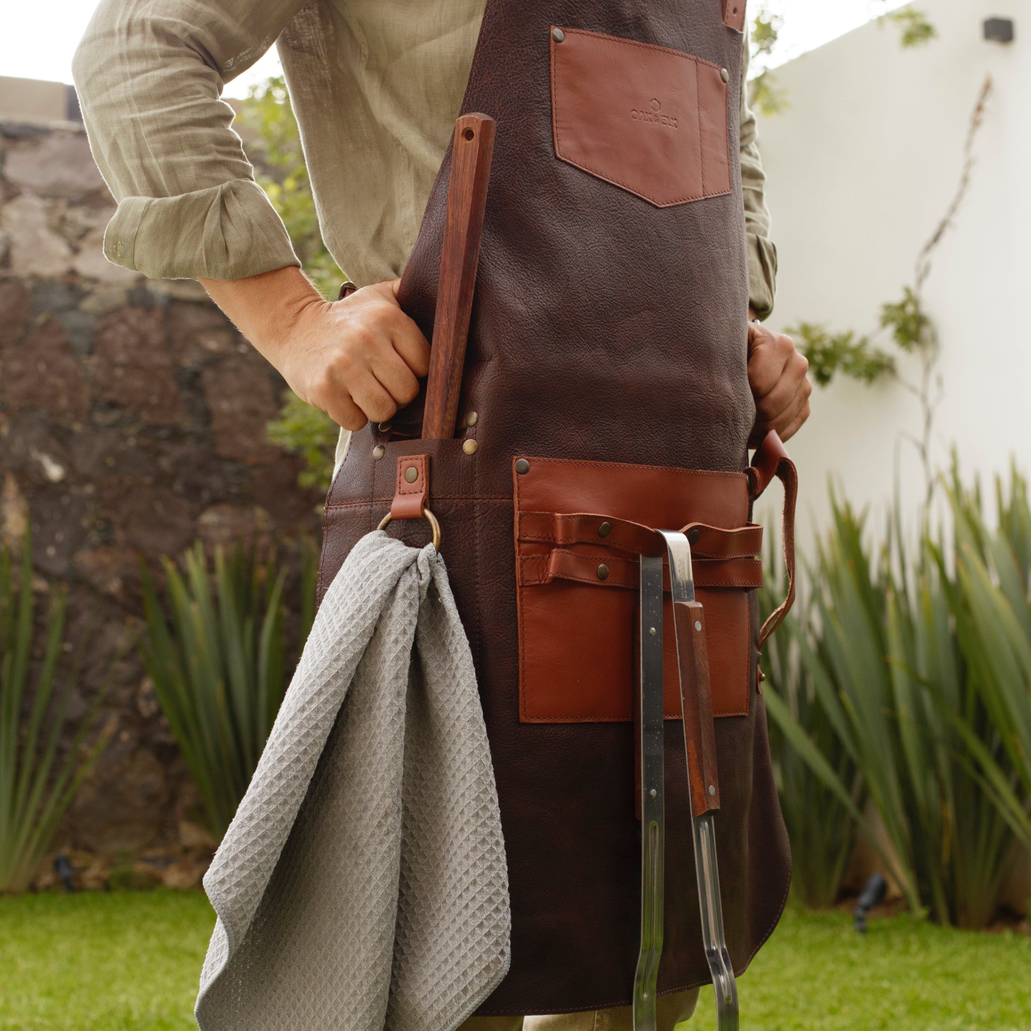 Full leather apron, adjustable straps, front chest pocket, tool loops, and rich texture, ideal for grilling, crafts, shop use
