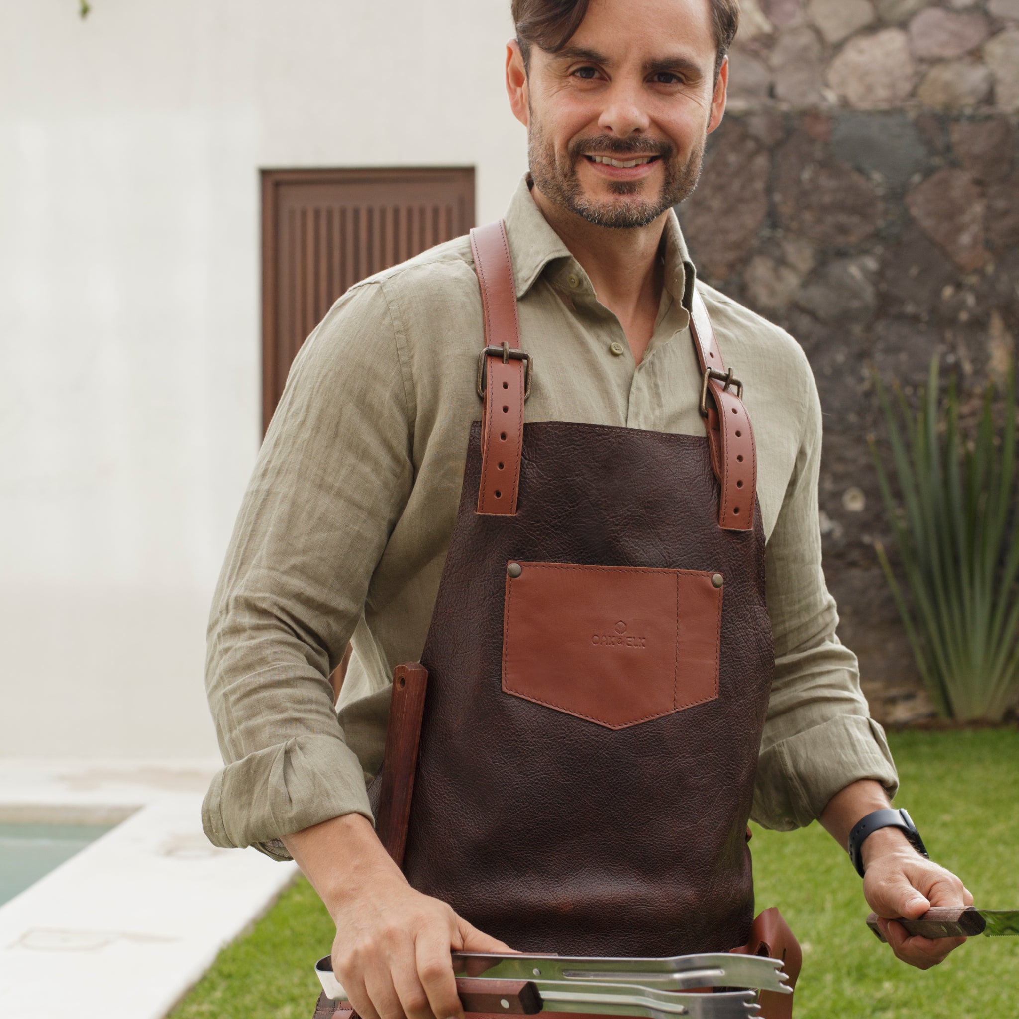 Full leather apron, adjustable straps, front chest pocket, tool loops, and rich texture, ideal for grilling, crafts, shop use