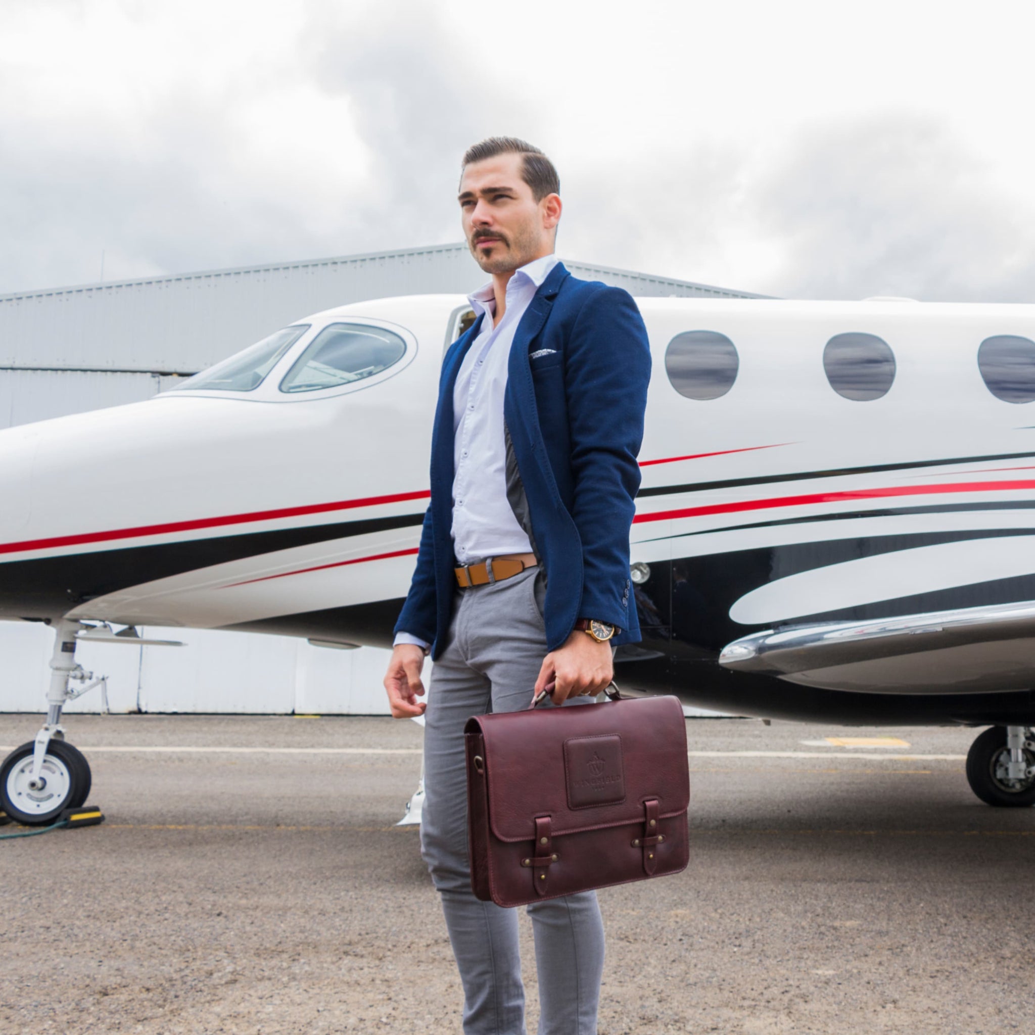 Leather messenger bag with flap closure, buckle details, adjustable strap, and slim profile — ideal for work or travel.