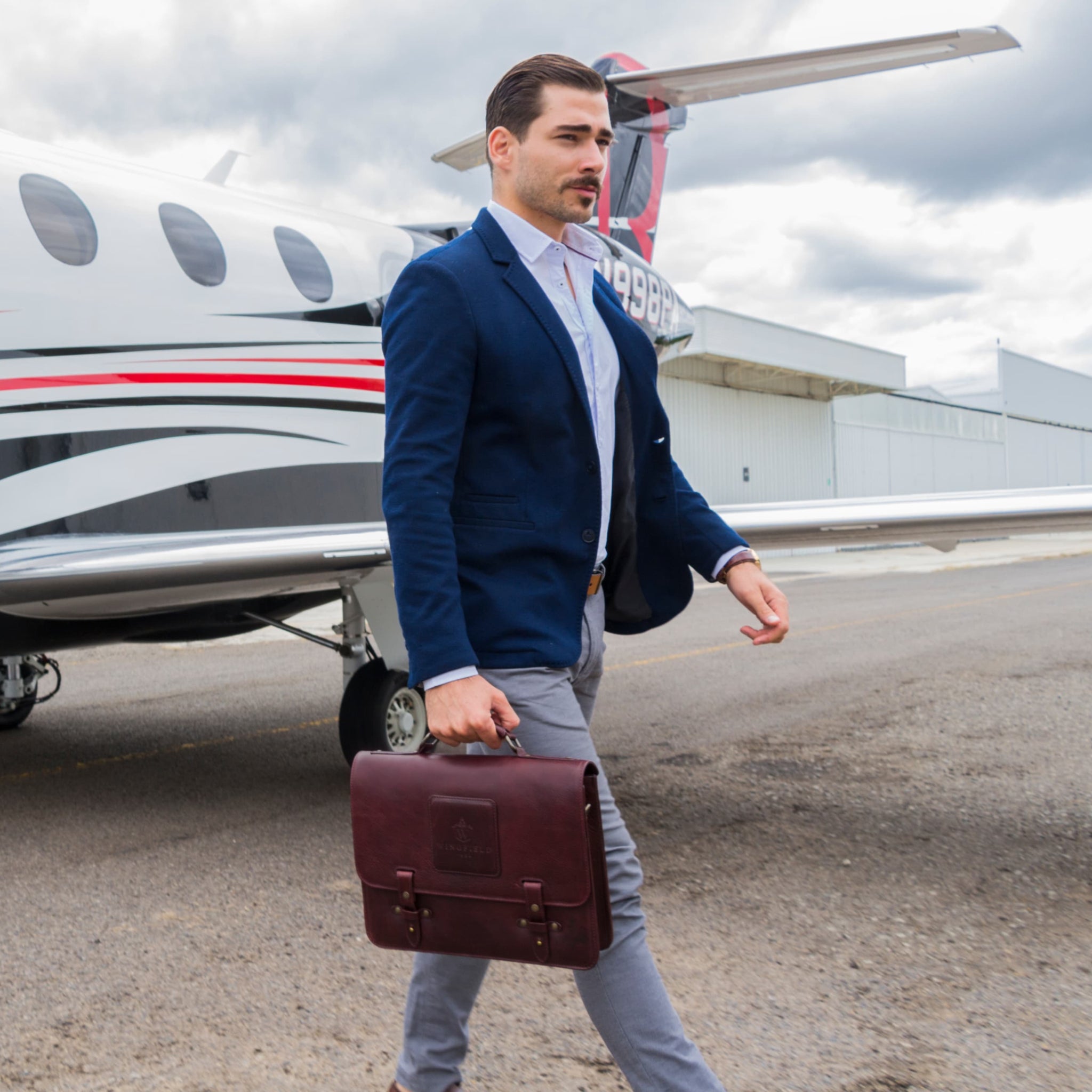 Leather messenger bag with flap closure, buckle details, adjustable strap, and slim profile — ideal for work or travel.