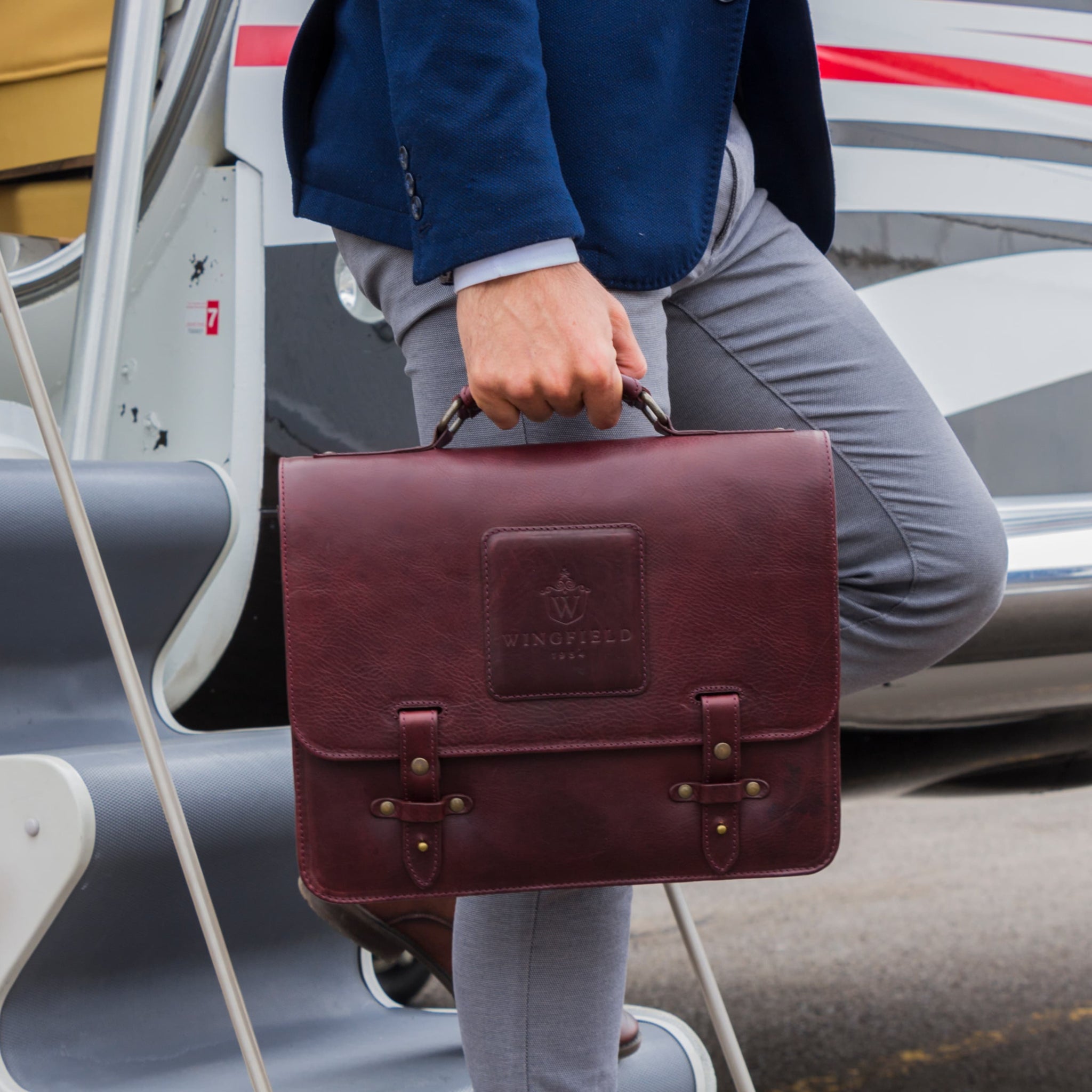 Leather messenger bag with flap closure, buckle details, adjustable strap, and slim profile — ideal for work or travel.