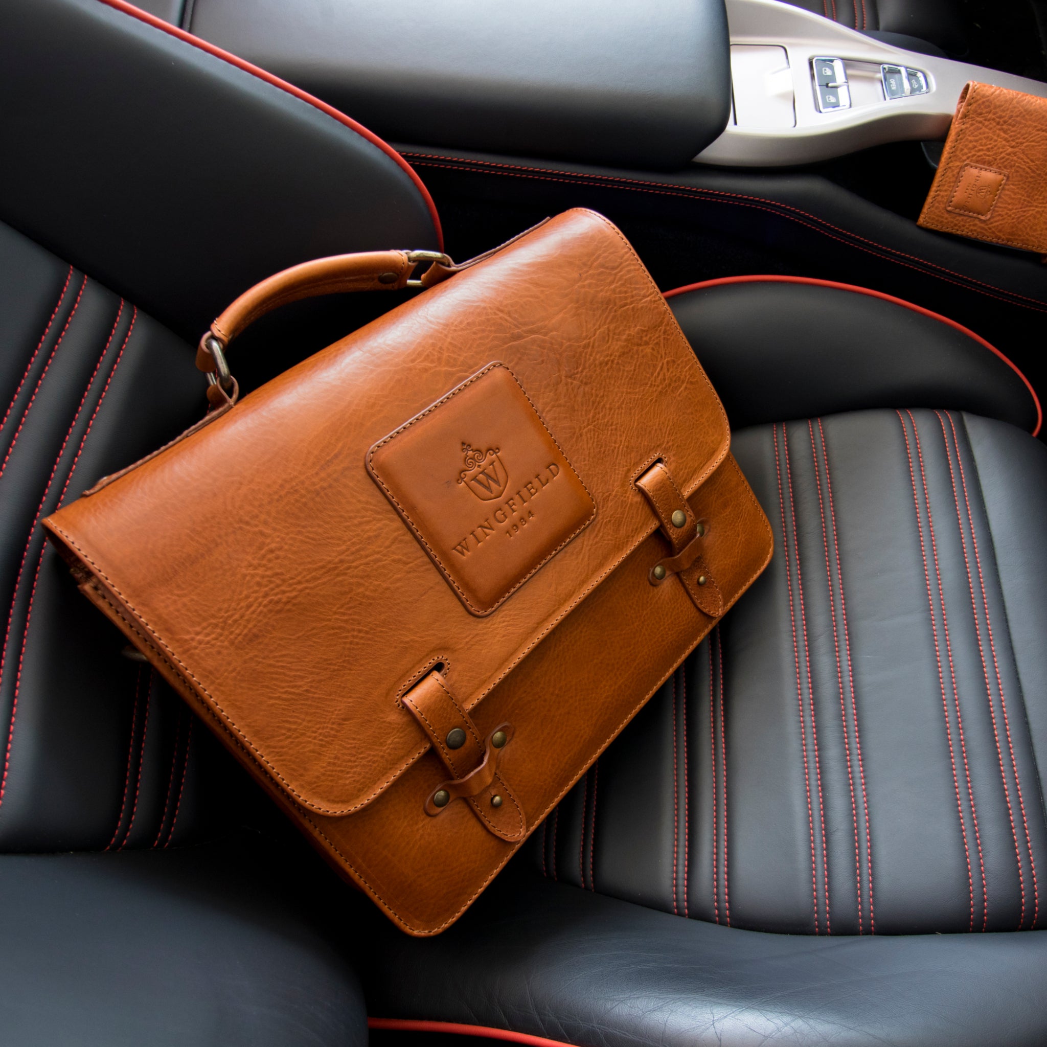 Leather messenger bag with flap closure, buckle details, adjustable strap, and slim profile — ideal for work or travel.