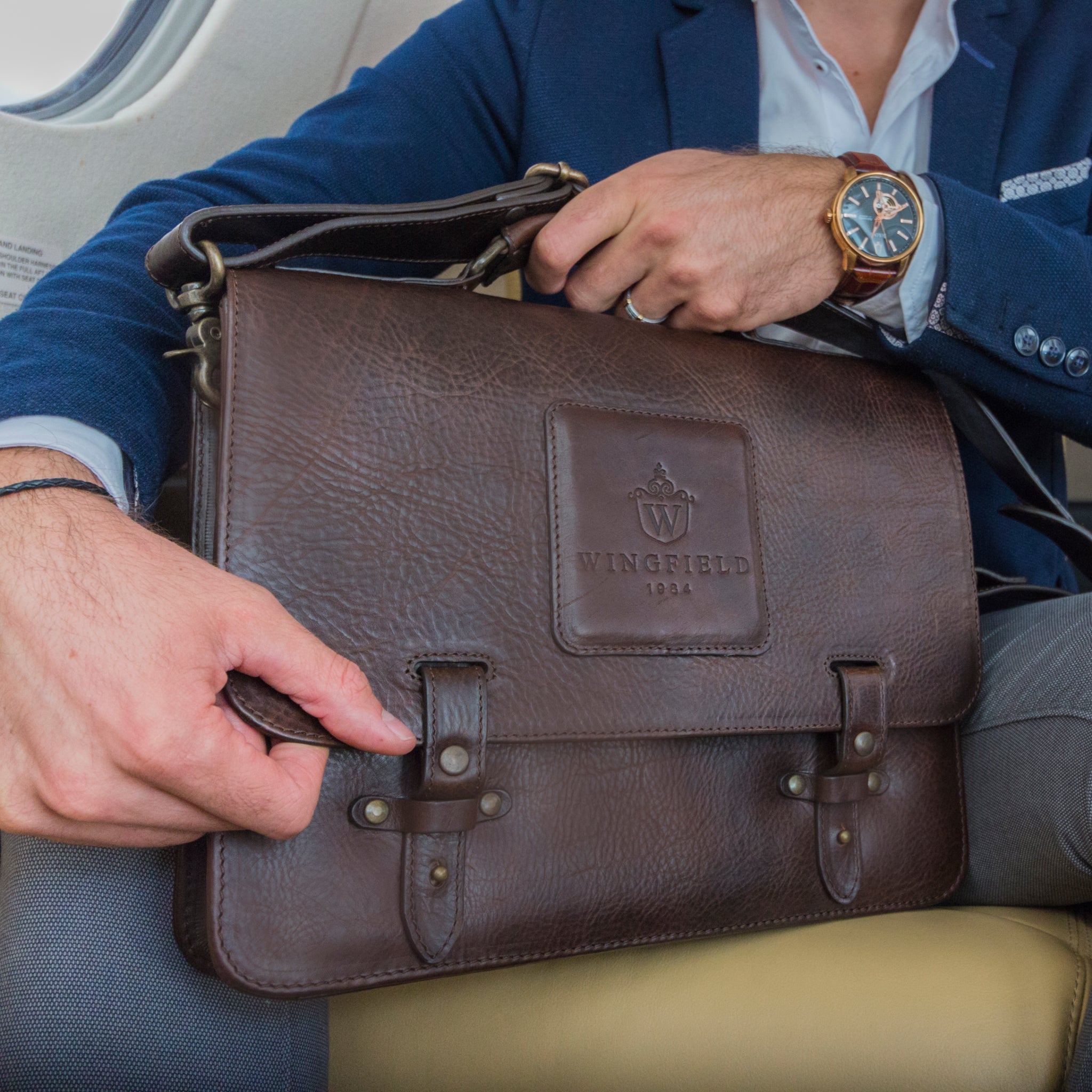 Leather messenger bag with flap closure, buckle details, adjustable strap, and slim profile — ideal for work or travel.