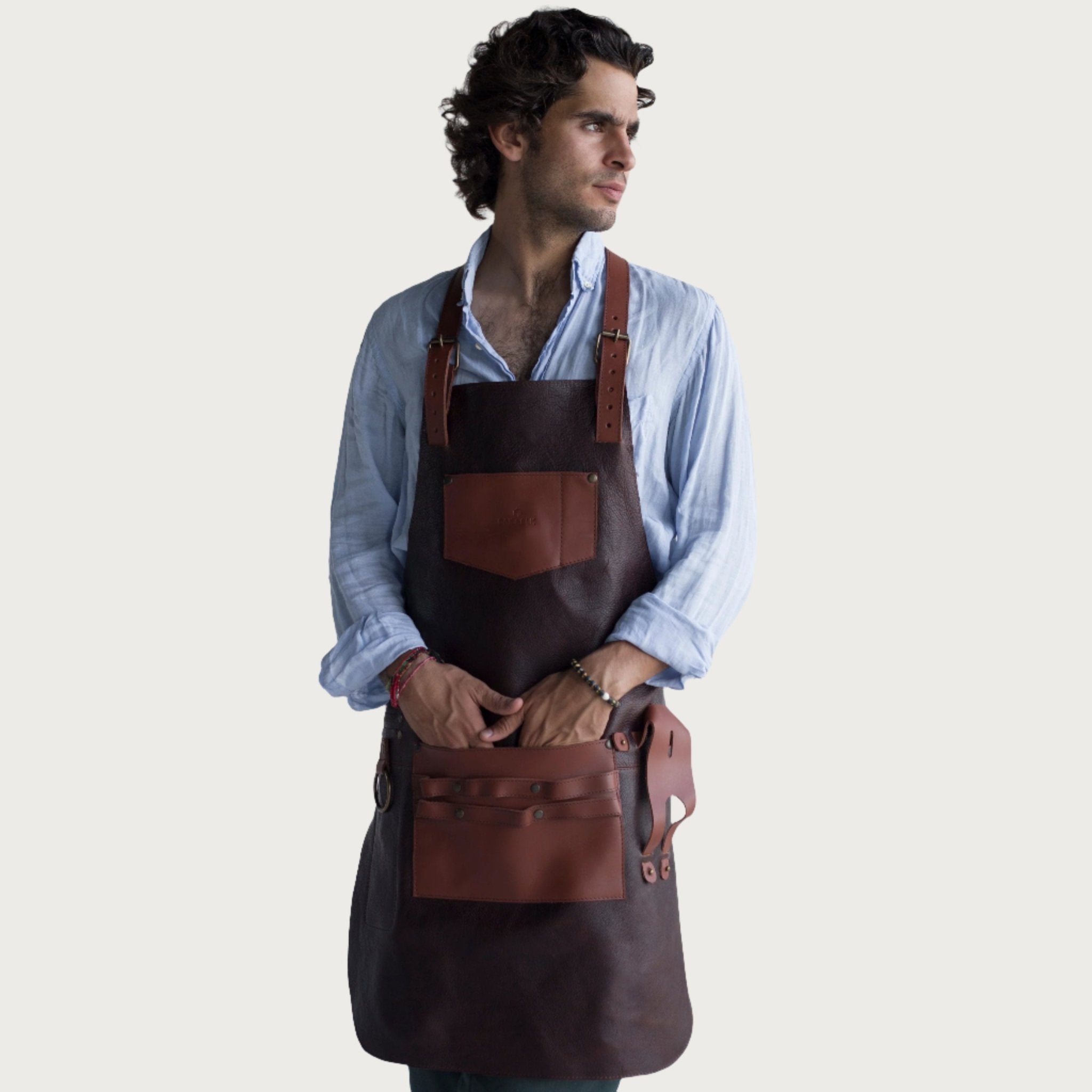 Full leather apron, adjustable straps, front chest pocket, tool loops, and rich texture, ideal for grilling, crafts, shop use