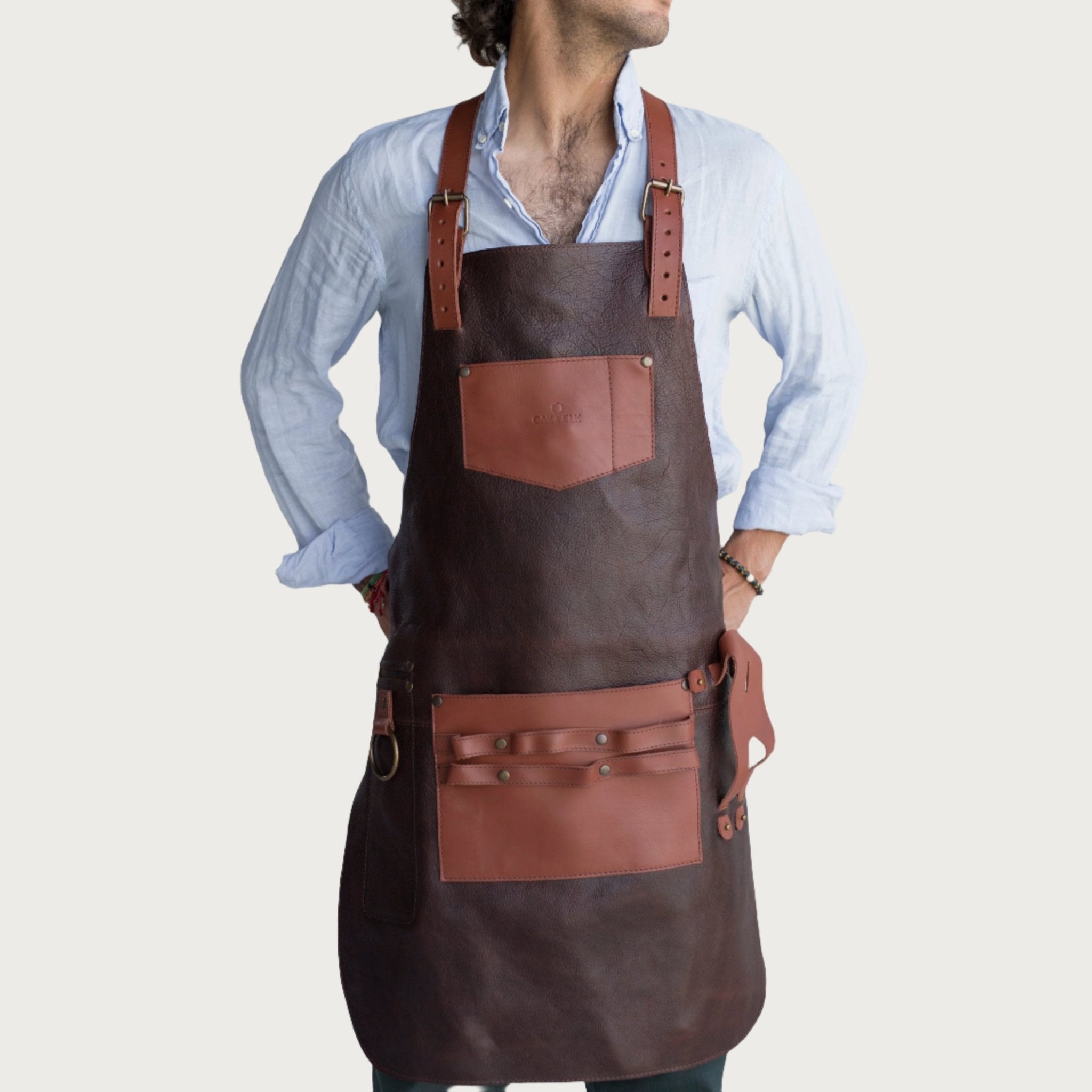 Full leather apron, adjustable straps, front chest pocket, tool loops, and rich texture, ideal for grilling, crafts, shop use