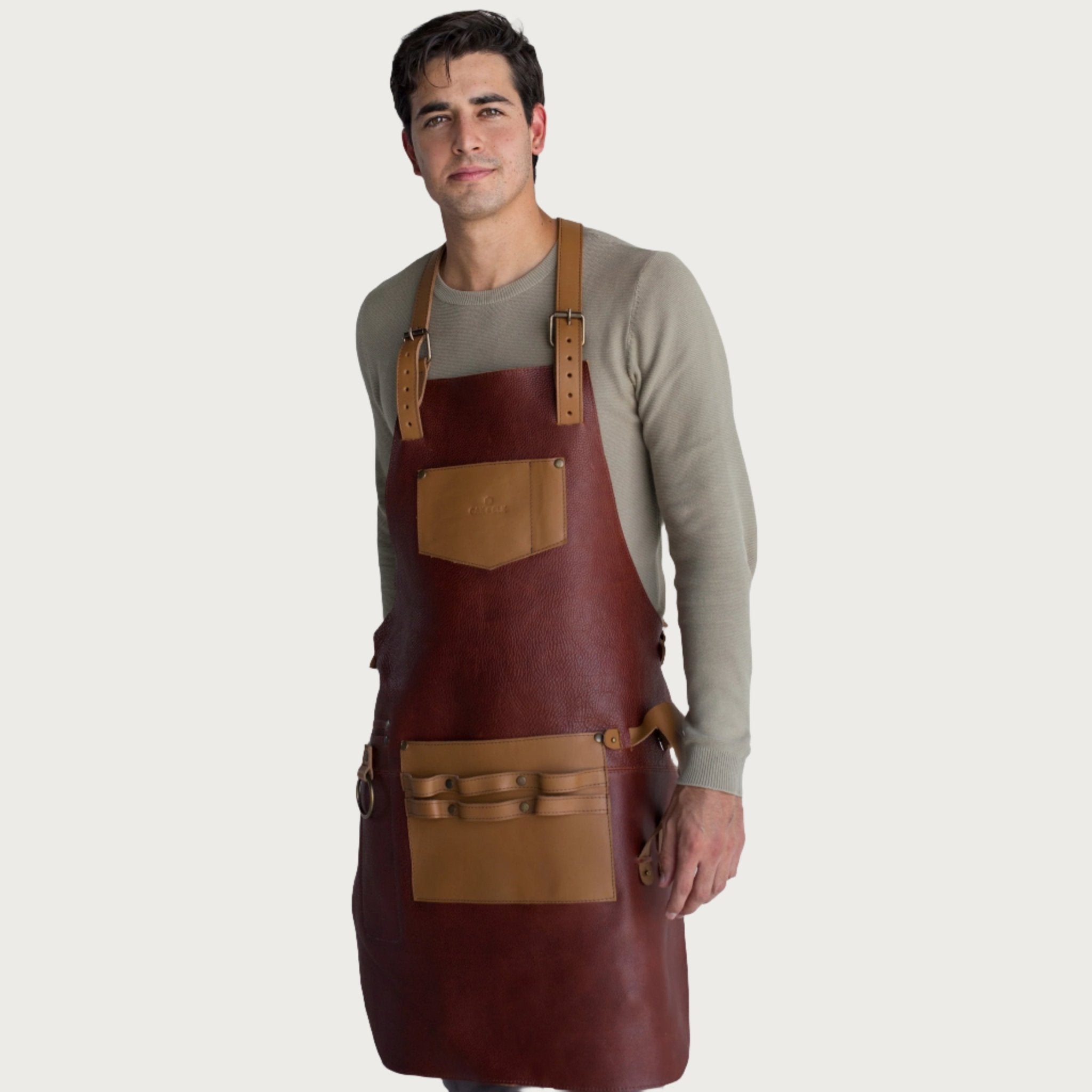 Full leather apron, adjustable straps, front chest pocket, tool loops, and rich texture, ideal for grilling, crafts, shop use