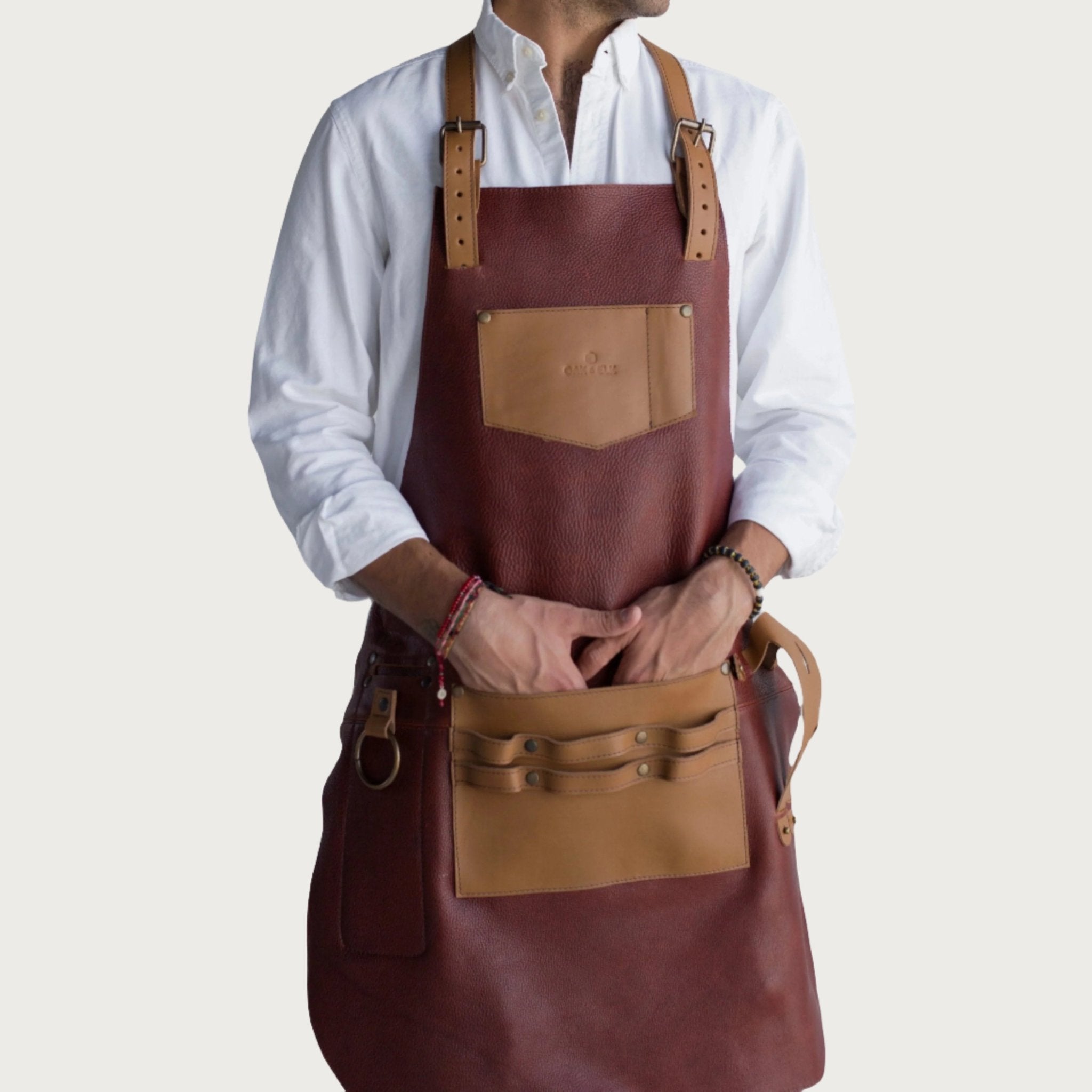 Full leather apron, adjustable straps, front chest pocket, tool loops, and rich texture, ideal for grilling, crafts, shop use