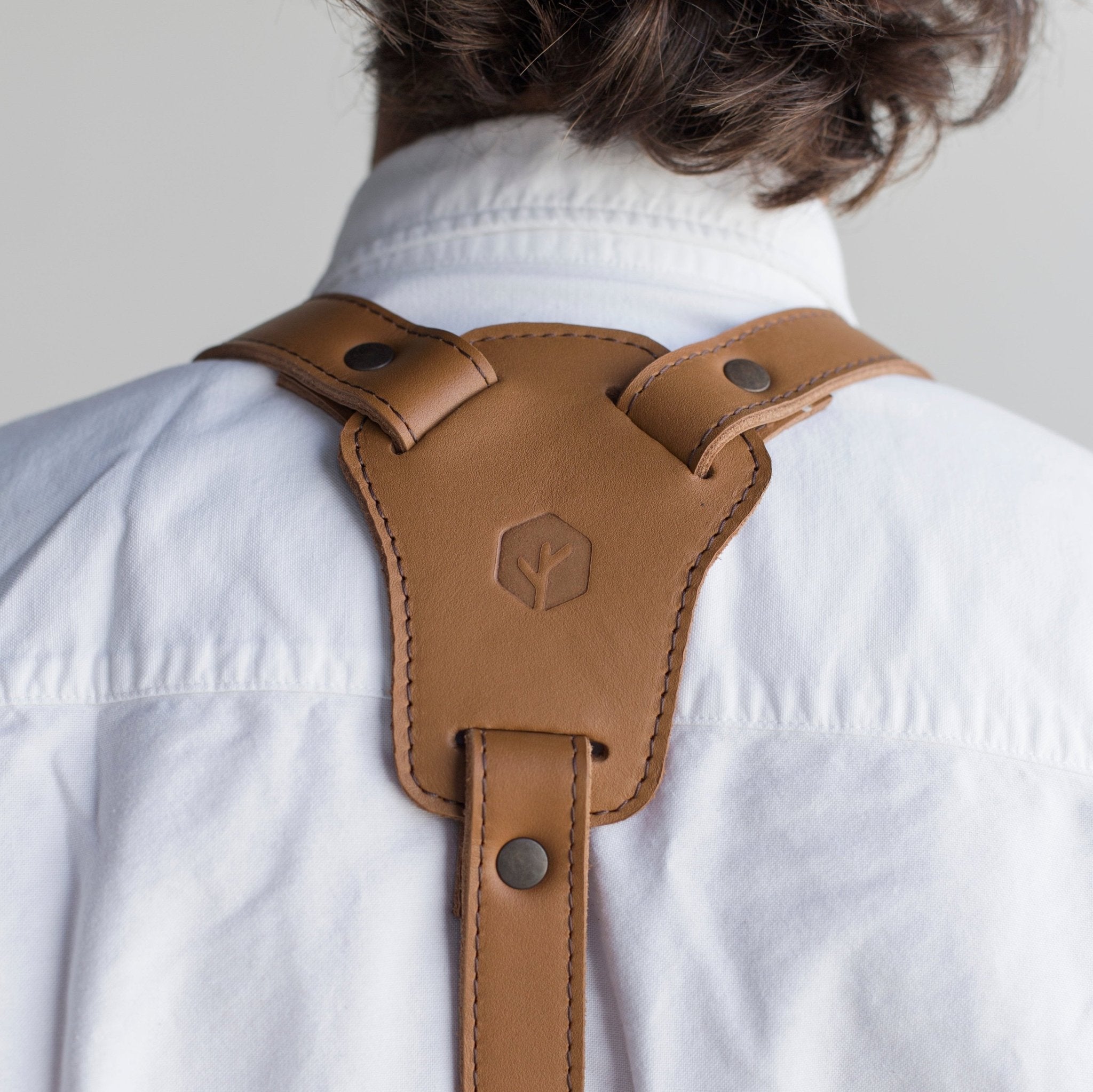 Full leather apron, adjustable straps, front chest pocket, tool loops, and rich texture, ideal for grilling, crafts, shop use