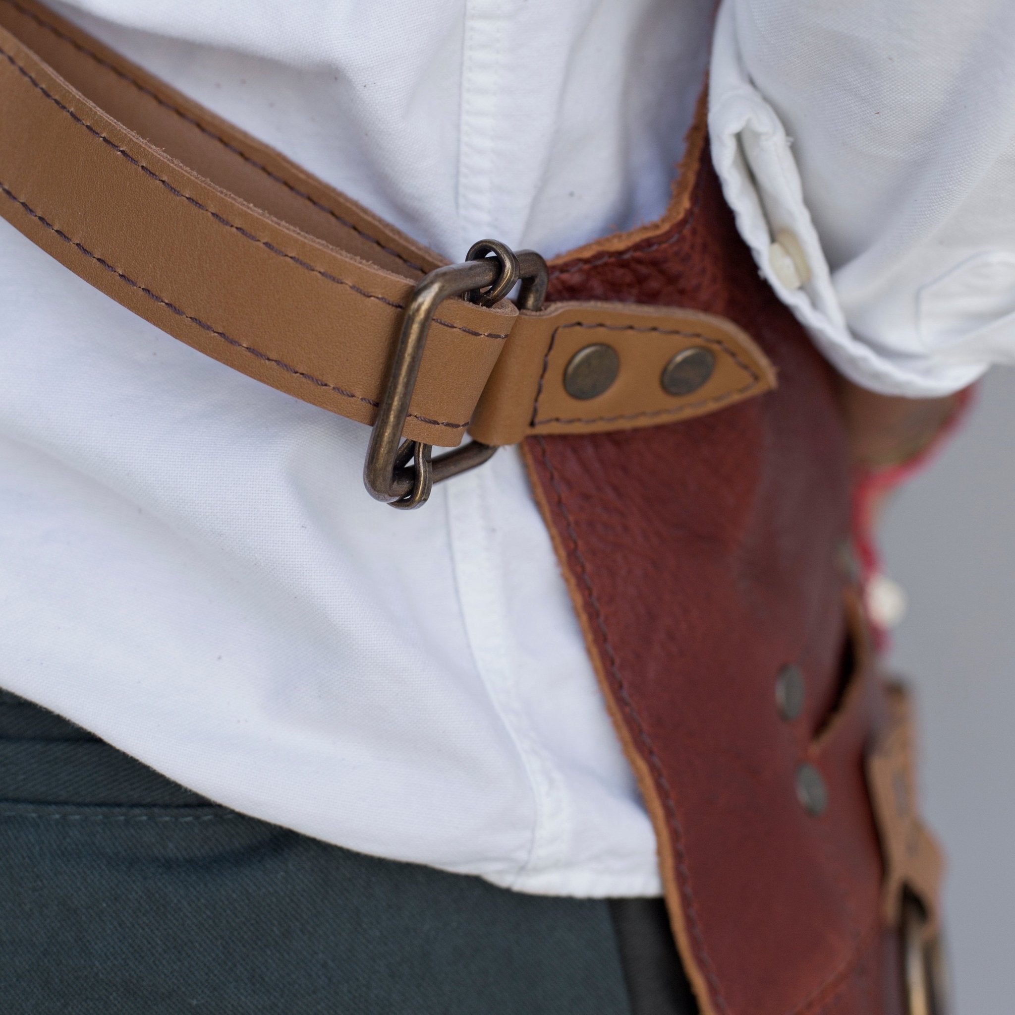 Full leather apron, adjustable straps, front chest pocket, tool loops, and rich texture, ideal for grilling, crafts, shop use