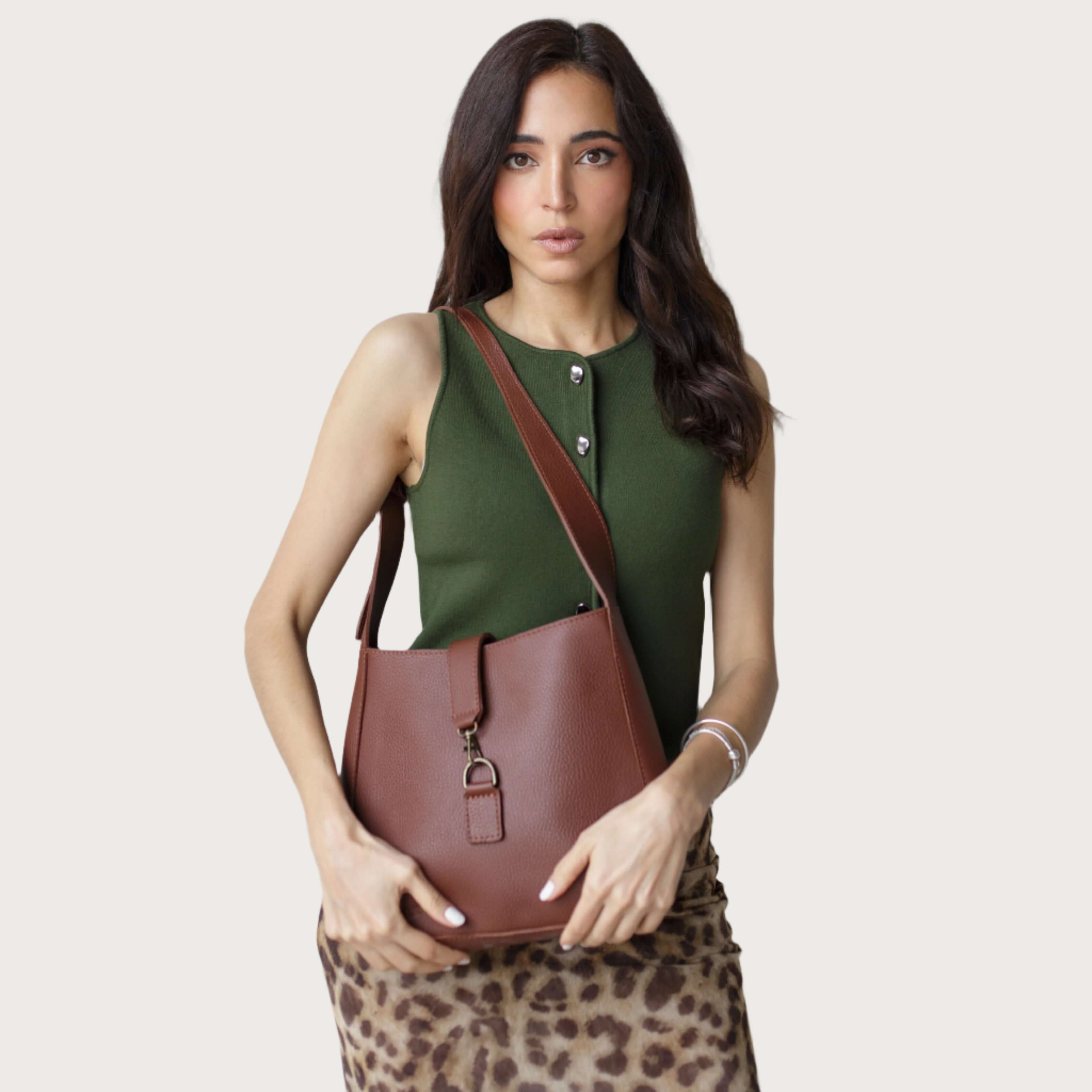 Full-grain leather shoulder bag with minimalist design, adjustable strap, interior pocket, soft structure, everyday essential