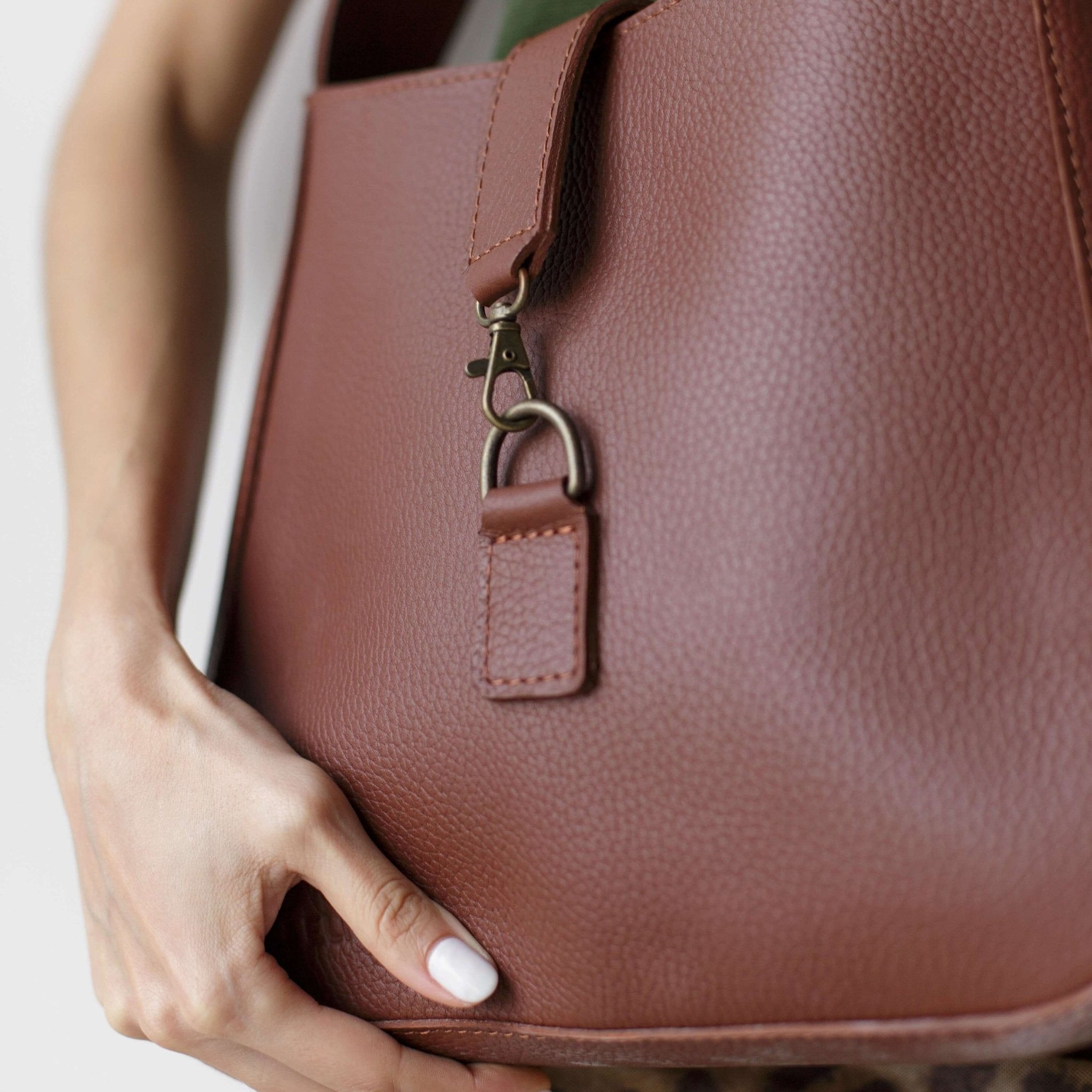 Full-grain leather shoulder bag with minimalist design, adjustable strap, interior pocket, soft structure, everyday essential