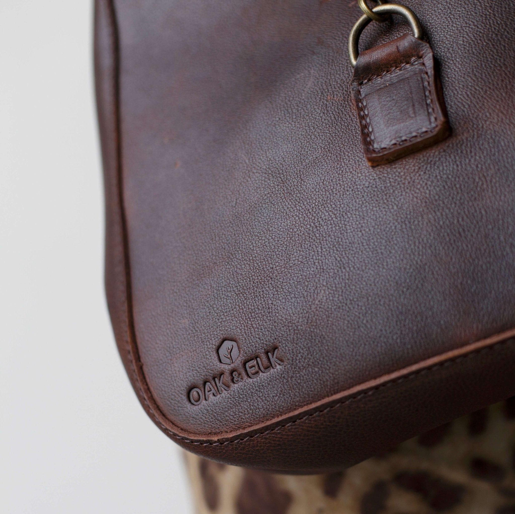 Full-grain leather shoulder bag with minimalist design, adjustable strap, interior pocket, soft structure, everyday essential