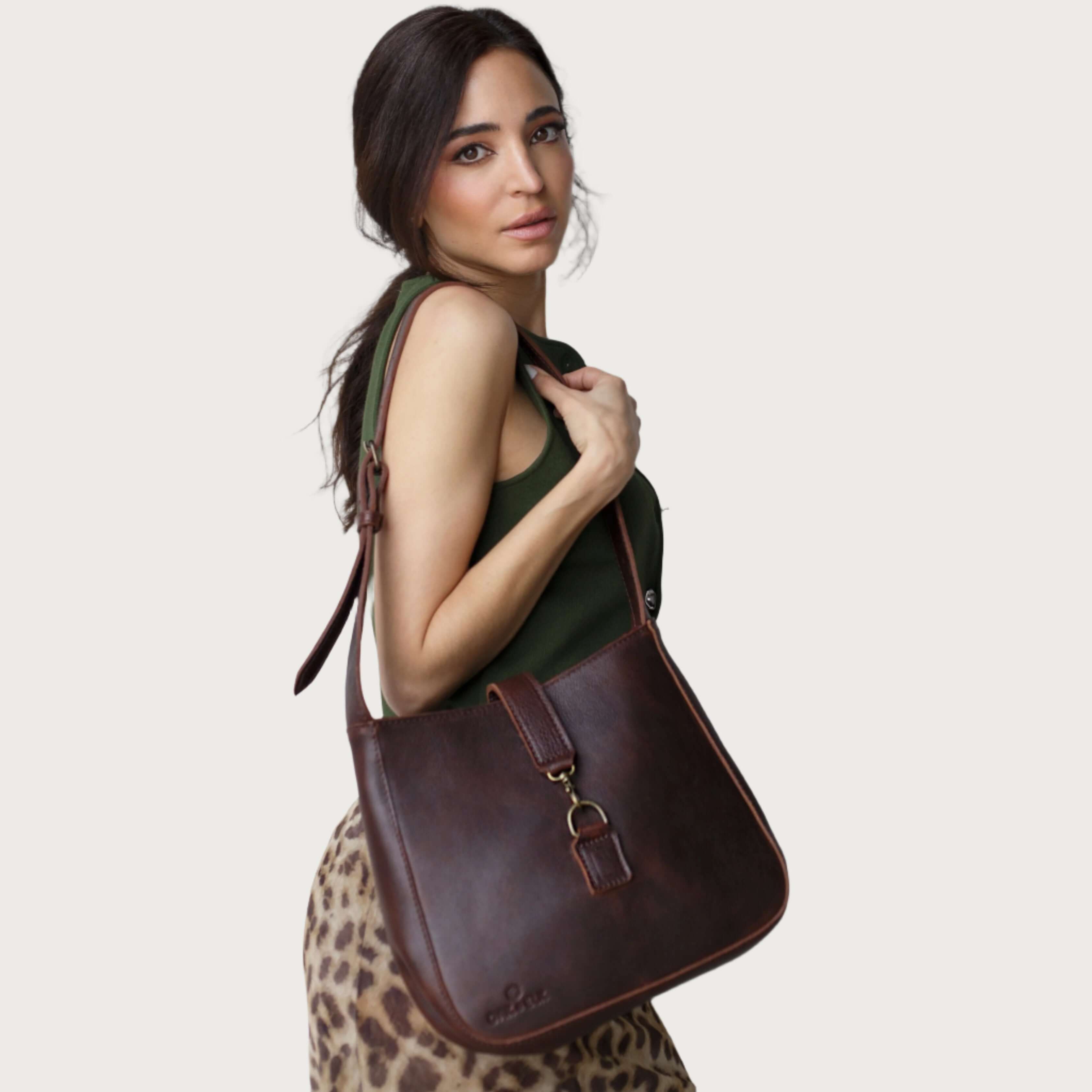 Full-grain leather shoulder bag with minimalist design, adjustable strap, interior pocket, soft structure, everyday essential