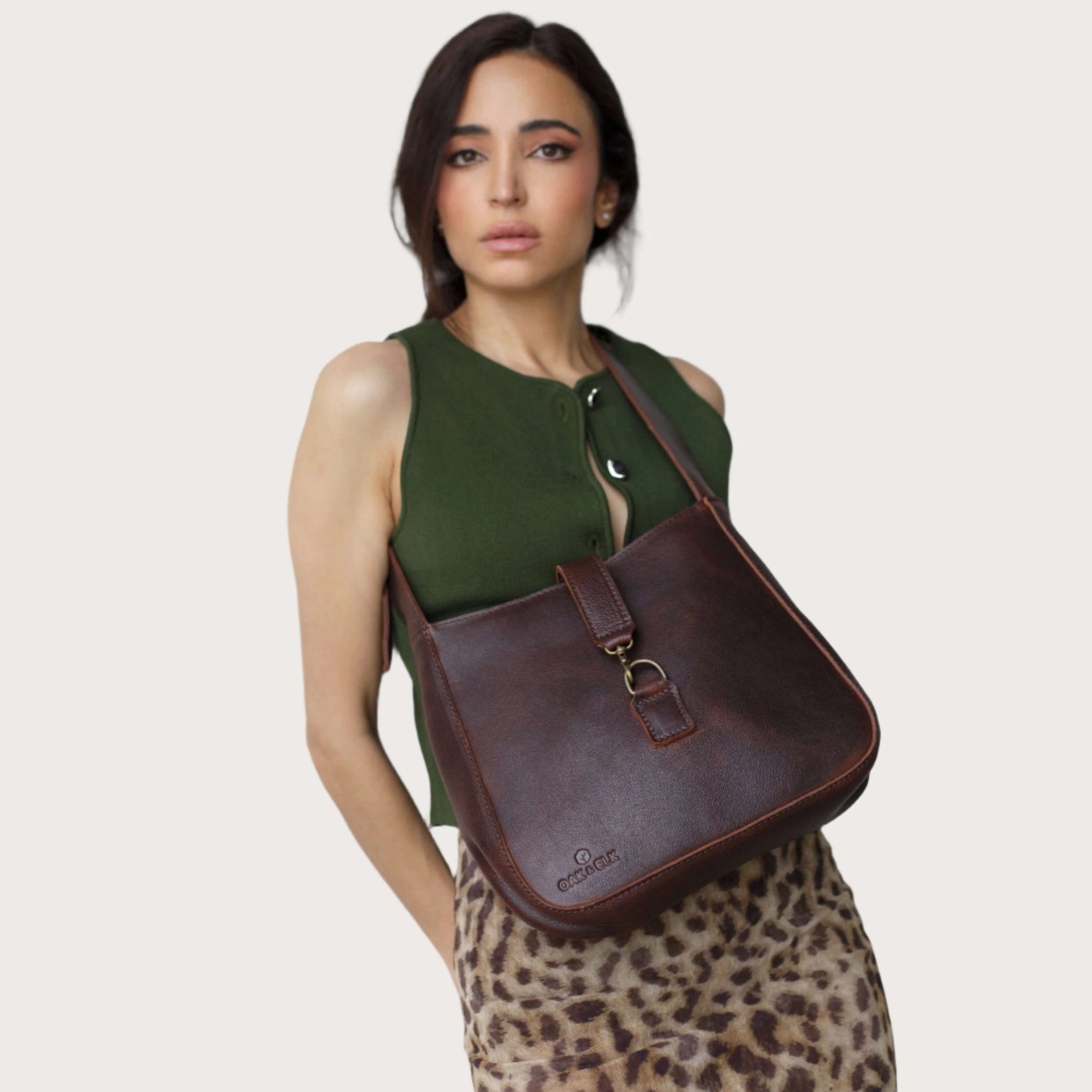Full-grain leather shoulder bag with minimalist design, adjustable strap, interior pocket, soft structure, everyday essential