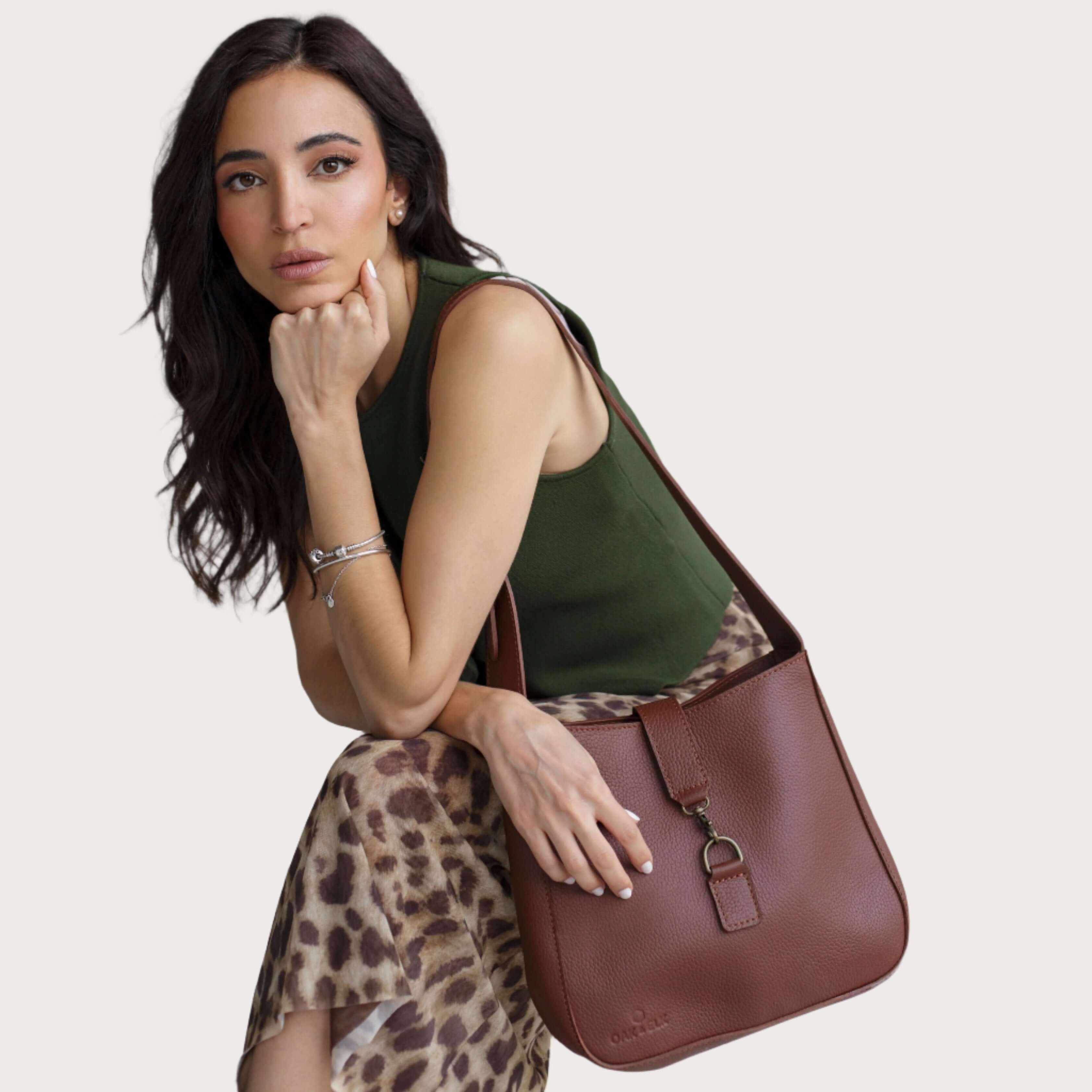 Full-grain leather shoulder bag with minimalist design, adjustable strap, interior pocket, soft structure, everyday essential