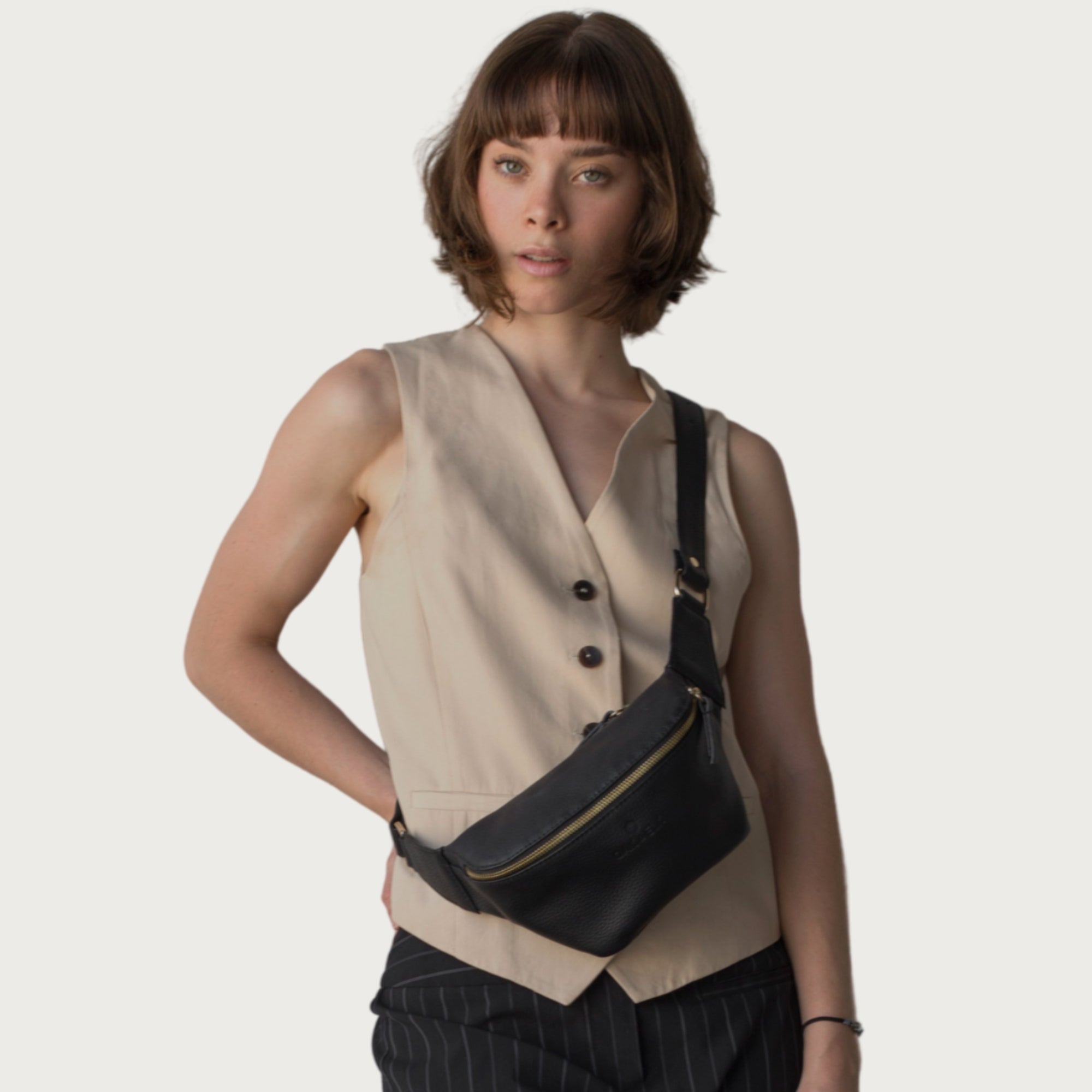 Black leather fanny pack with multiple compartments, zipper pockets, and adjustable strap — sleek and practical for daily use