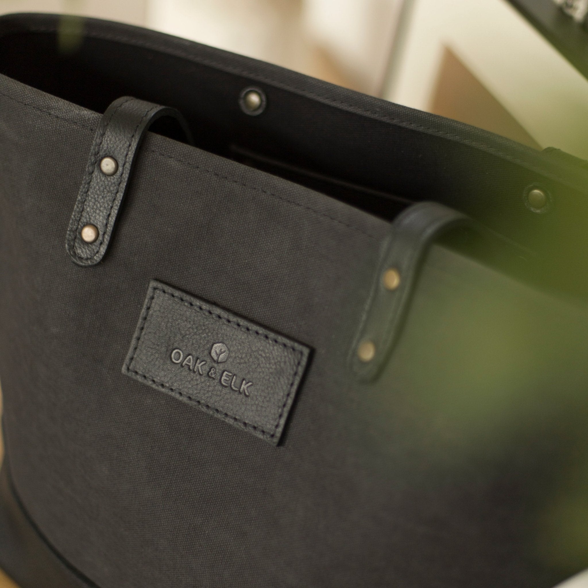 Canvas tote bag with leather trim, double shoulder straps, minimalist design, and roomy interior — ideal for daily use.