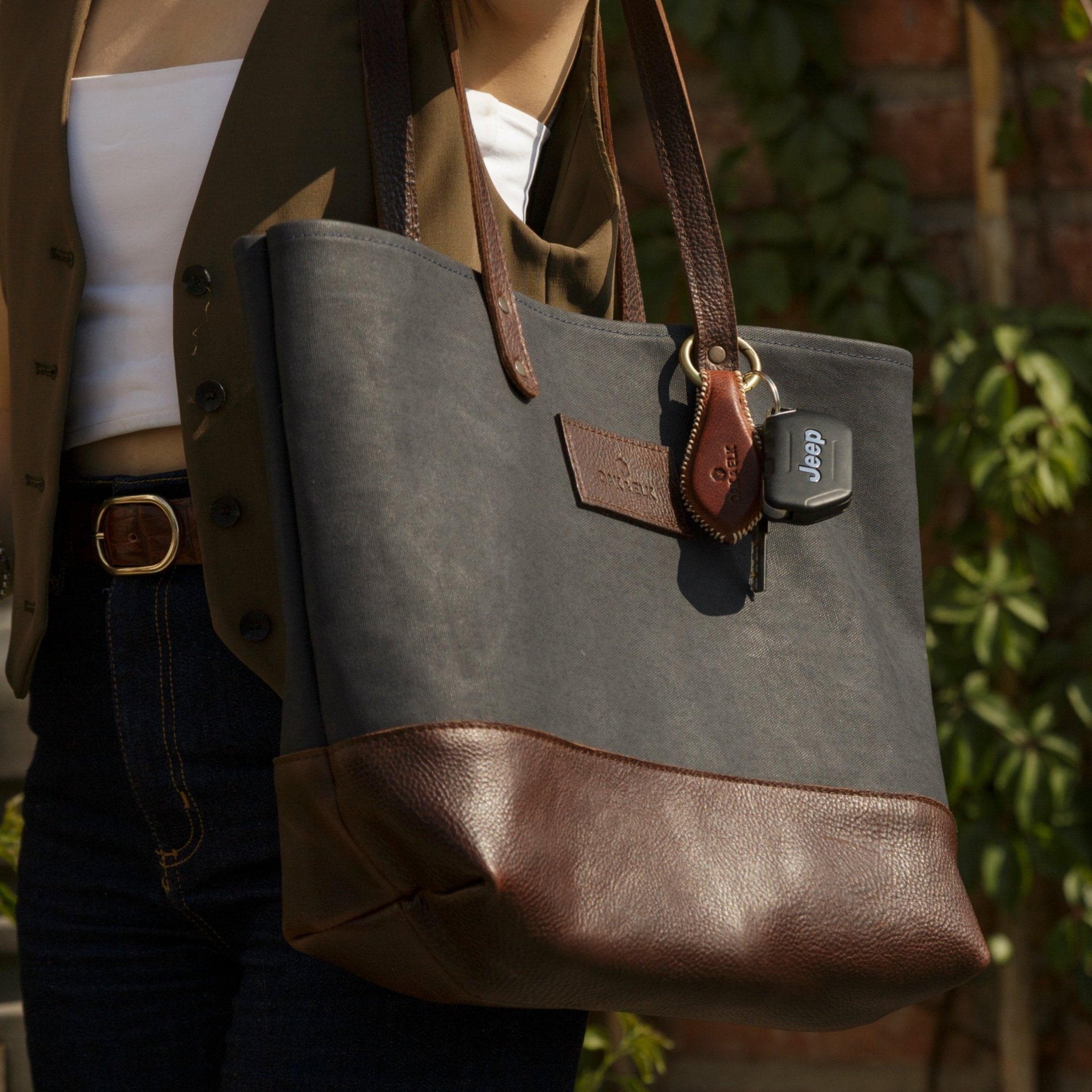 Canvas tote bag with leather trim, double shoulder straps, minimalist design, and roomy interior — ideal for daily use.