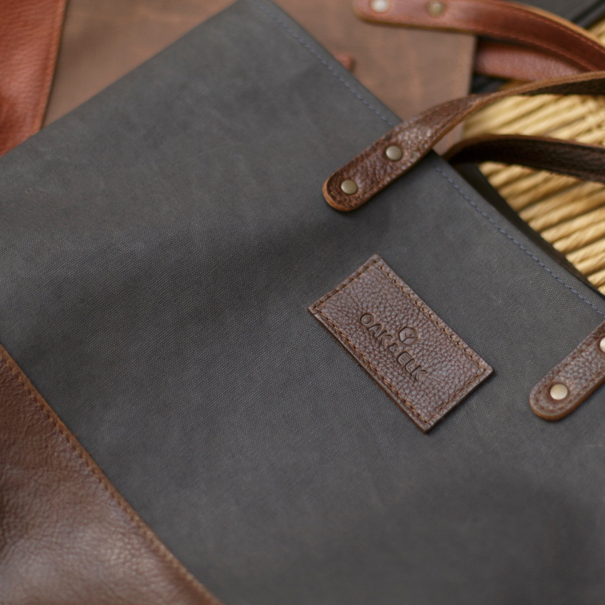 Canvas tote bag with leather trim, double shoulder straps, minimalist design, and roomy interior — ideal for daily use.