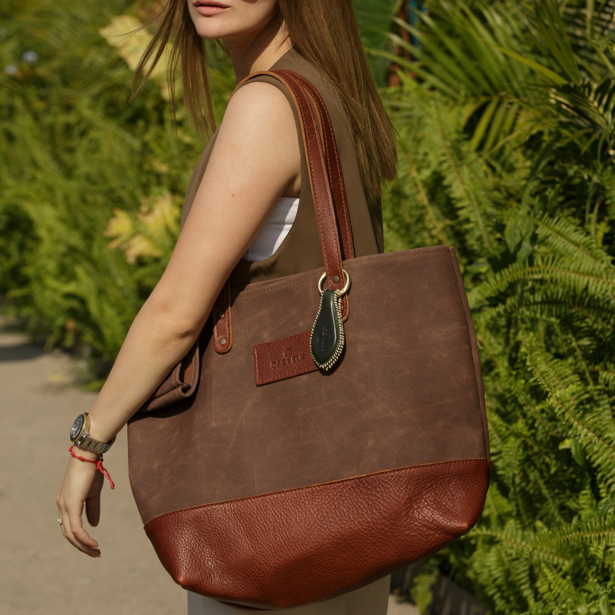 Canvas tote bag with leather trim, double shoulder straps, minimalist design, and roomy interior — ideal for daily use.