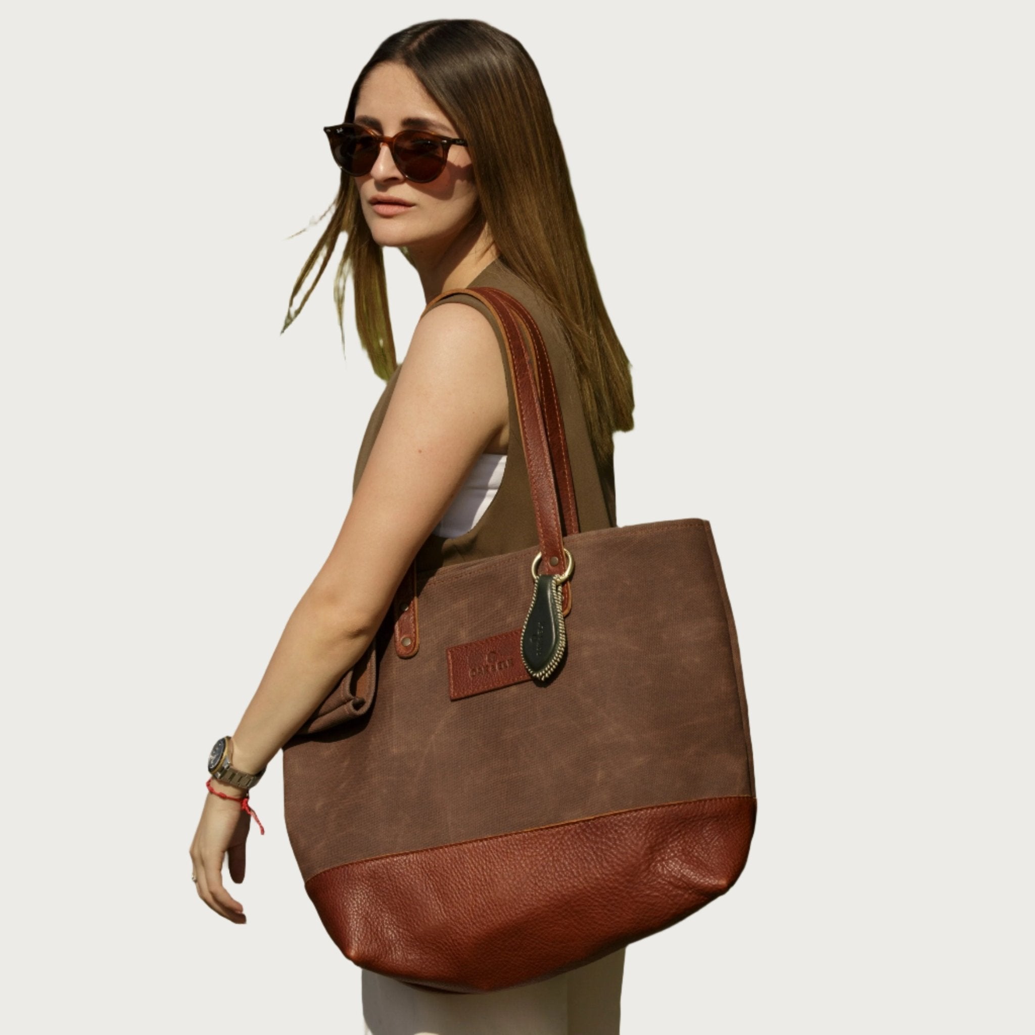 Canvas tote bag with leather trim, double shoulder straps, minimalist design, and roomy interior — ideal for daily use.