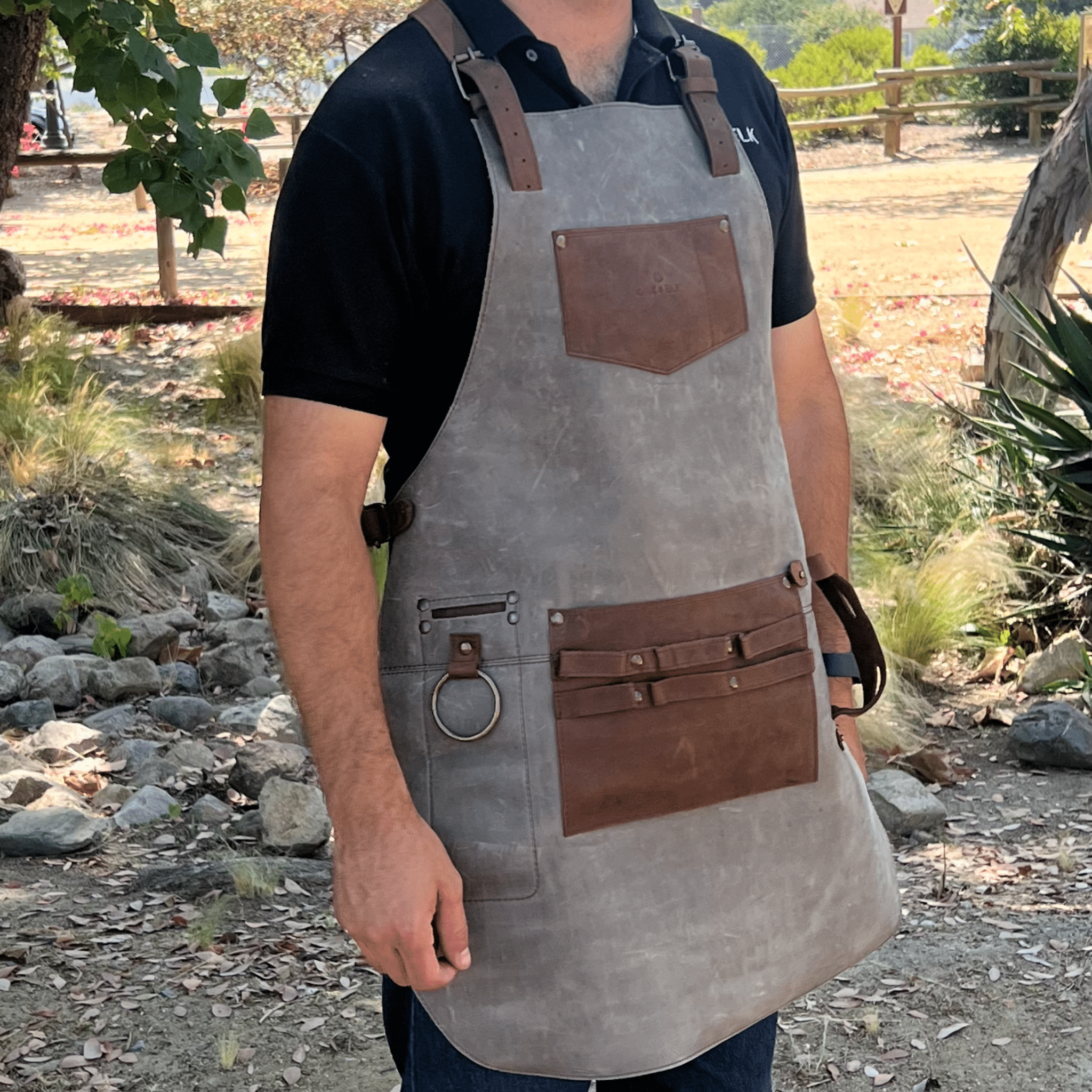Full leather apron, adjustable straps, front chest pocket, tool loops, and rich texture, ideal for grilling, crafts, shop use