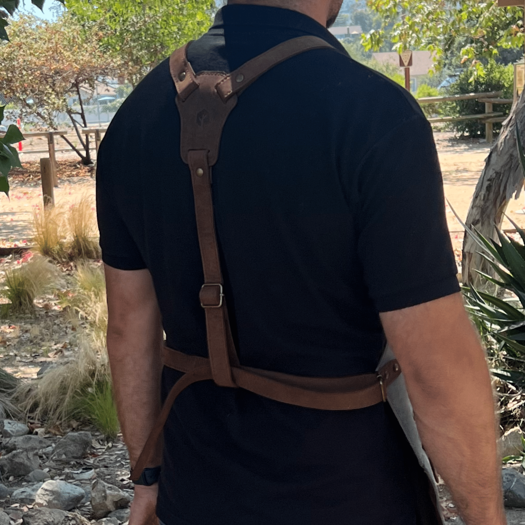 Full leather apron, adjustable straps, front chest pocket, tool loops, and rich texture, ideal for grilling, crafts, shop use