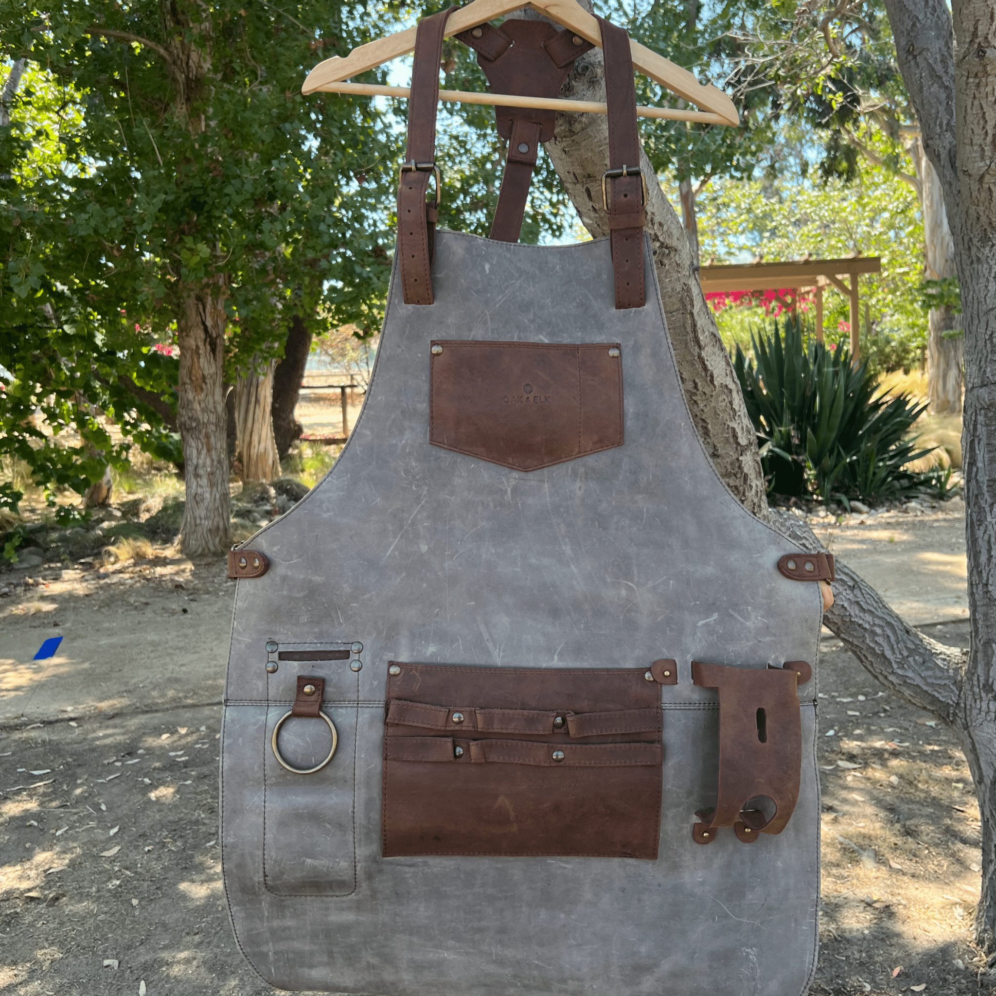 Full leather apron, adjustable straps, front chest pocket, tool loops, and rich texture, ideal for grilling, crafts, shop use