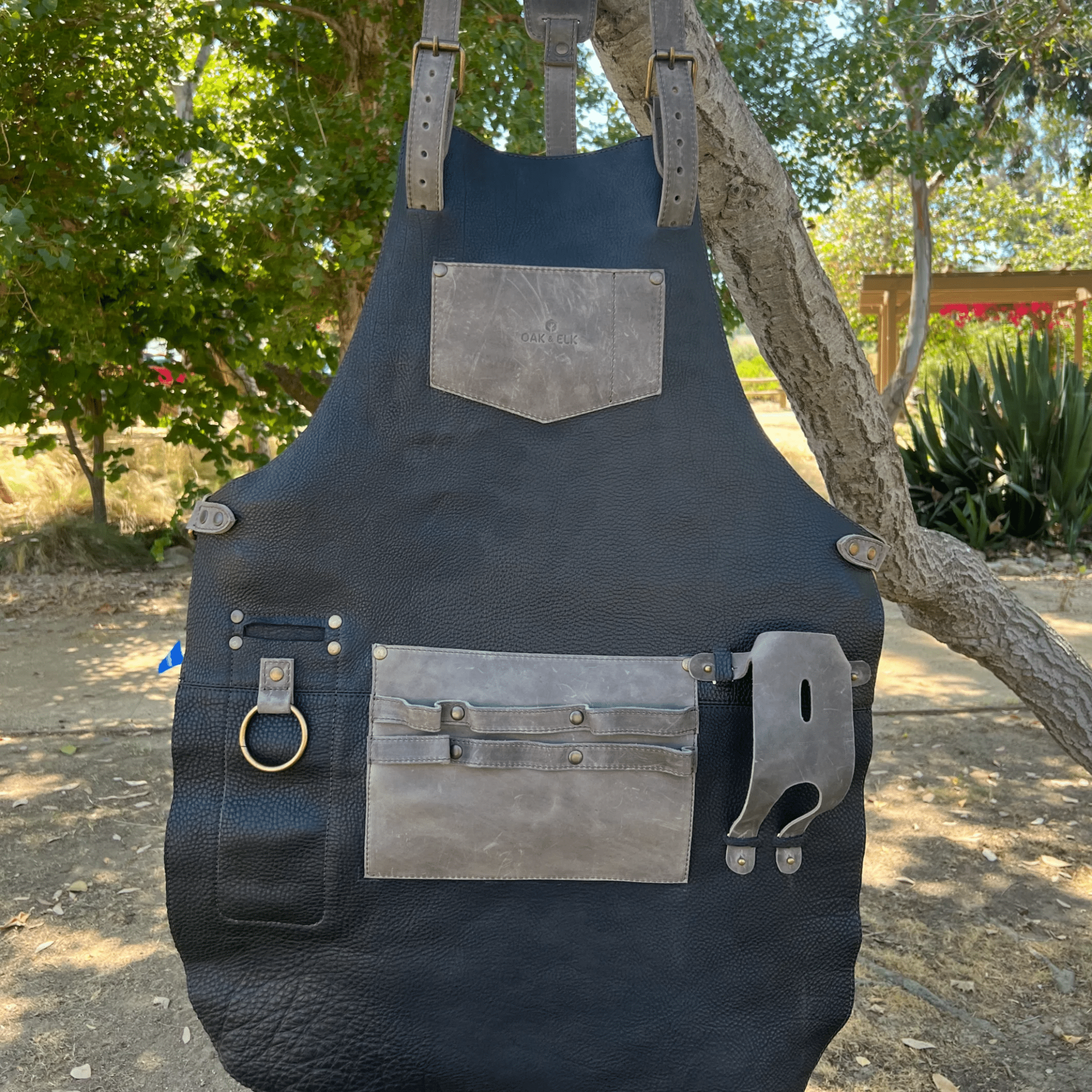 Full leather apron, adjustable straps, front chest pocket, tool loops, and rich texture, ideal for grilling, crafts, shop use