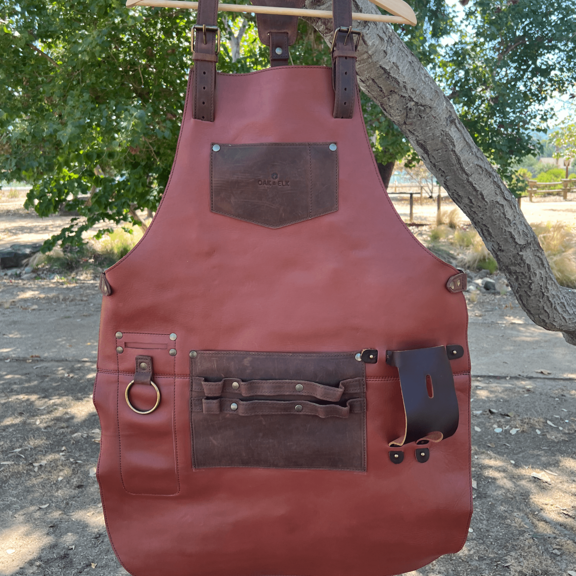 Full leather apron, adjustable straps, front chest pocket, tool loops, and rich texture, ideal for grilling, crafts, shop use