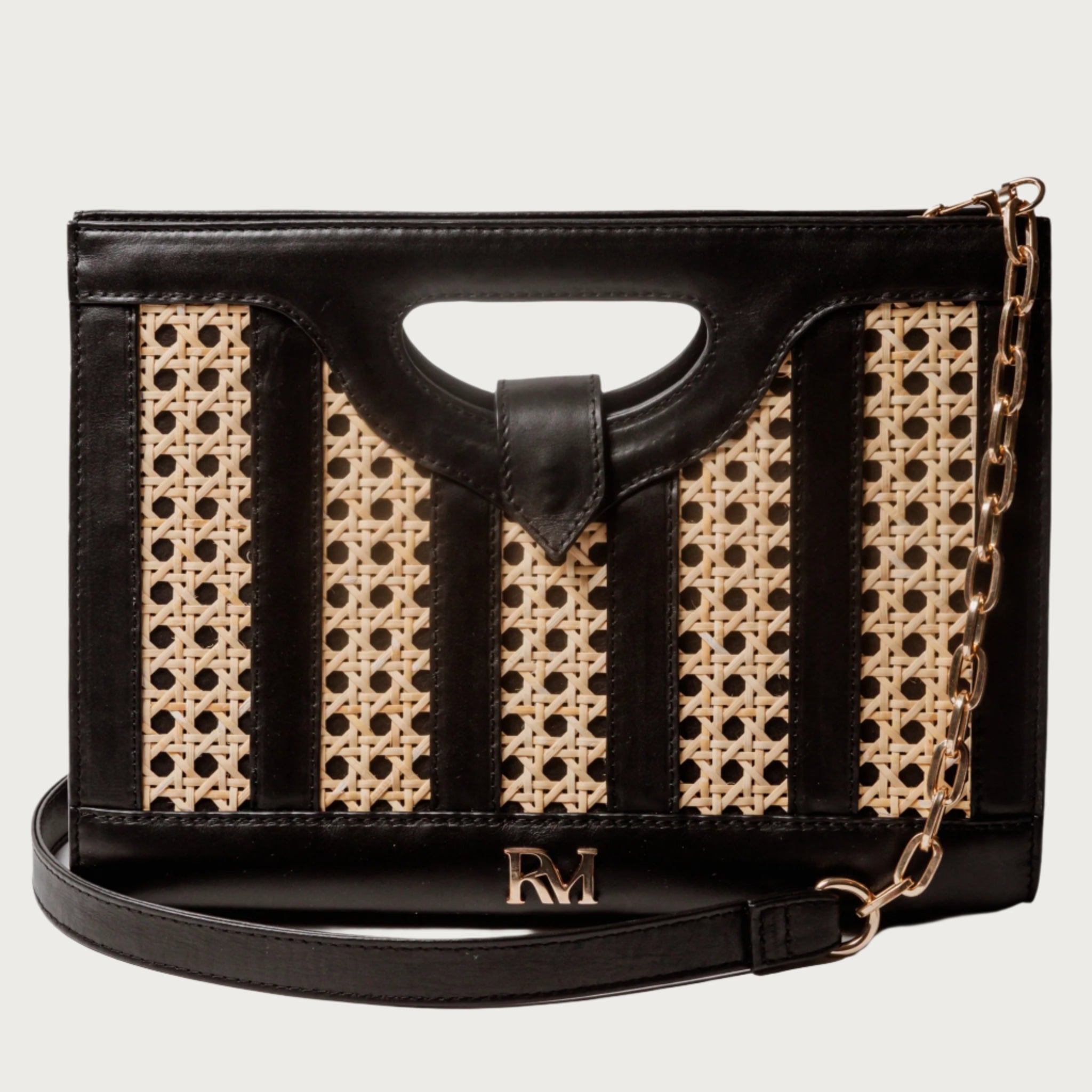 Handwoven wicker and black leather clutch with structured silhouette, cutout handle, and fabric lining bold elegant design