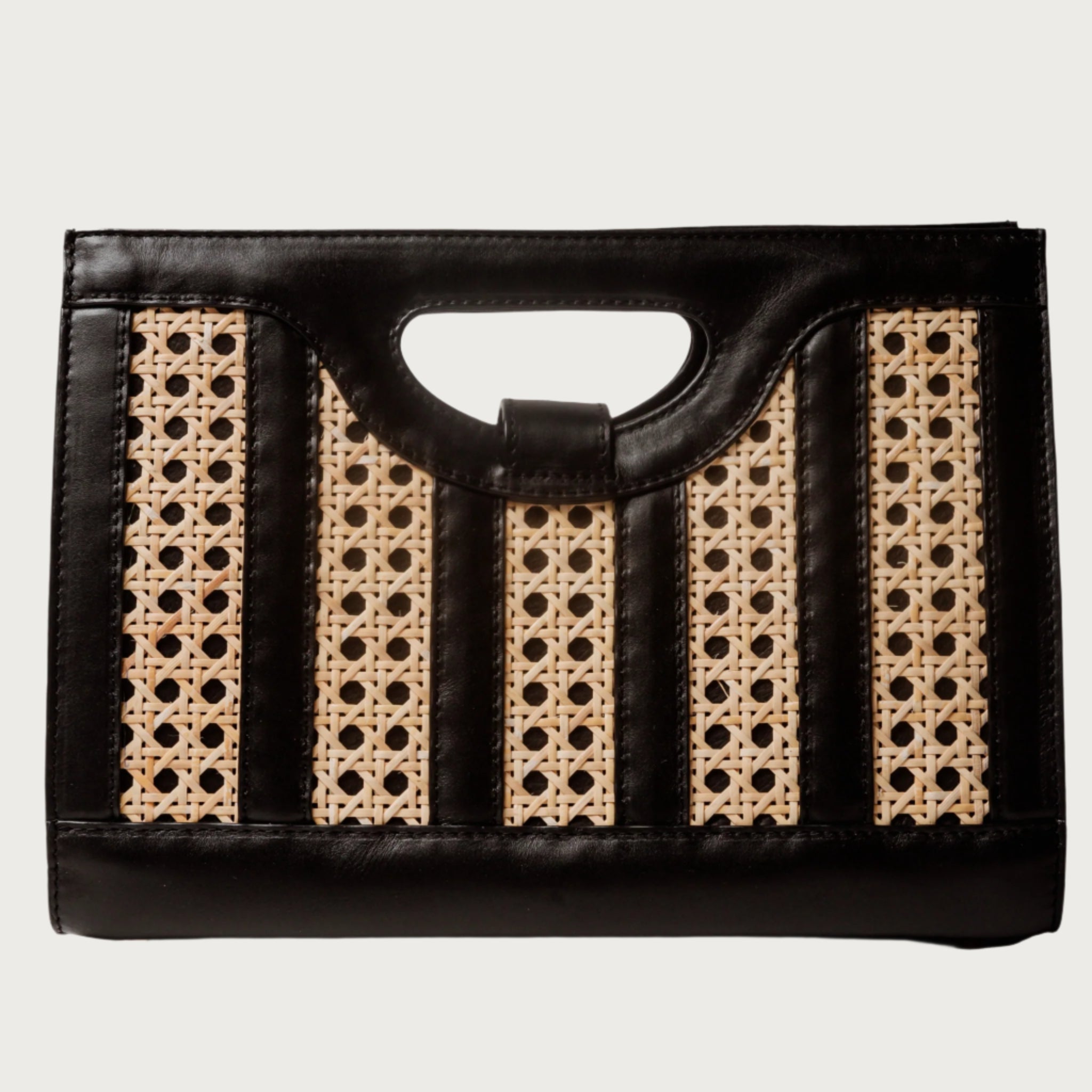 Handwoven wicker and black leather clutch with structured silhouette, cutout handle, and fabric lining bold elegant design